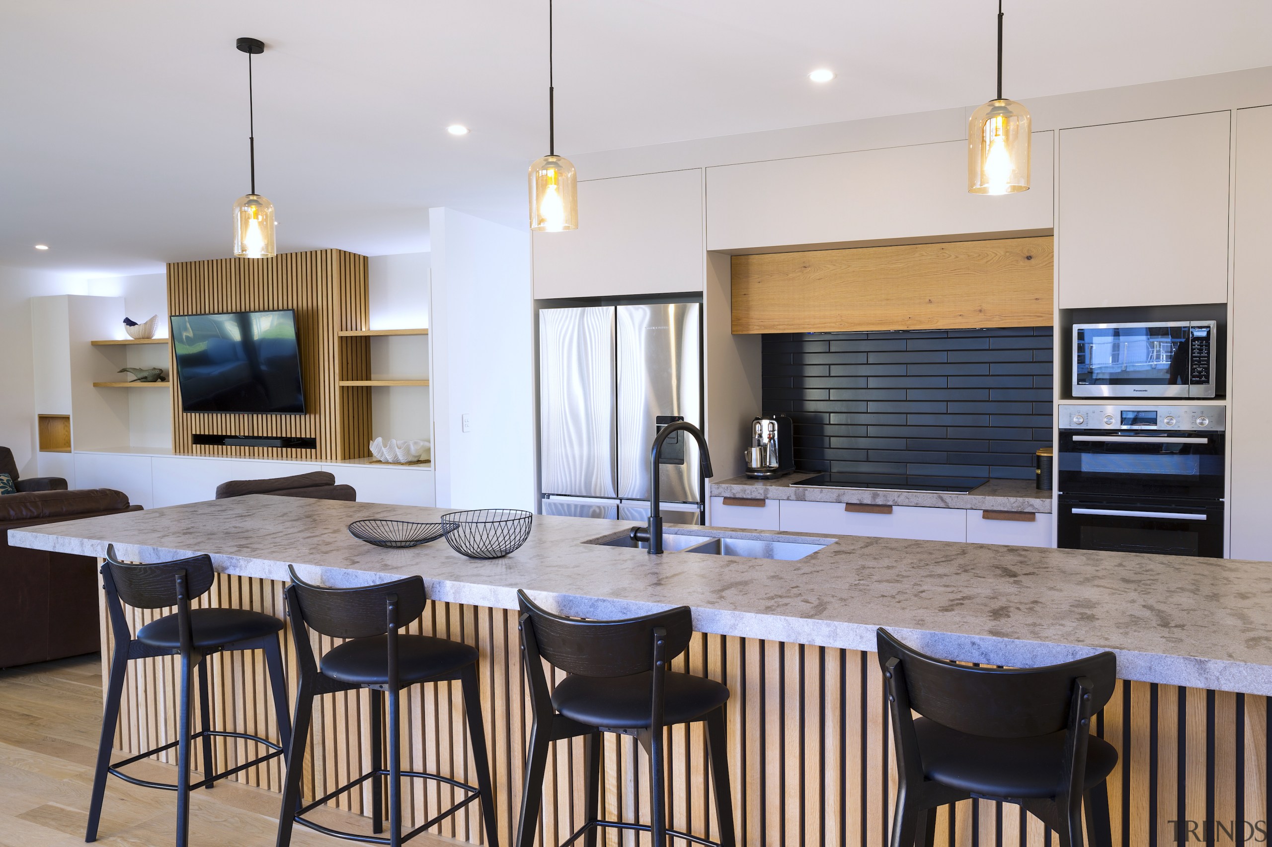 A batten finish behind the television is carried 