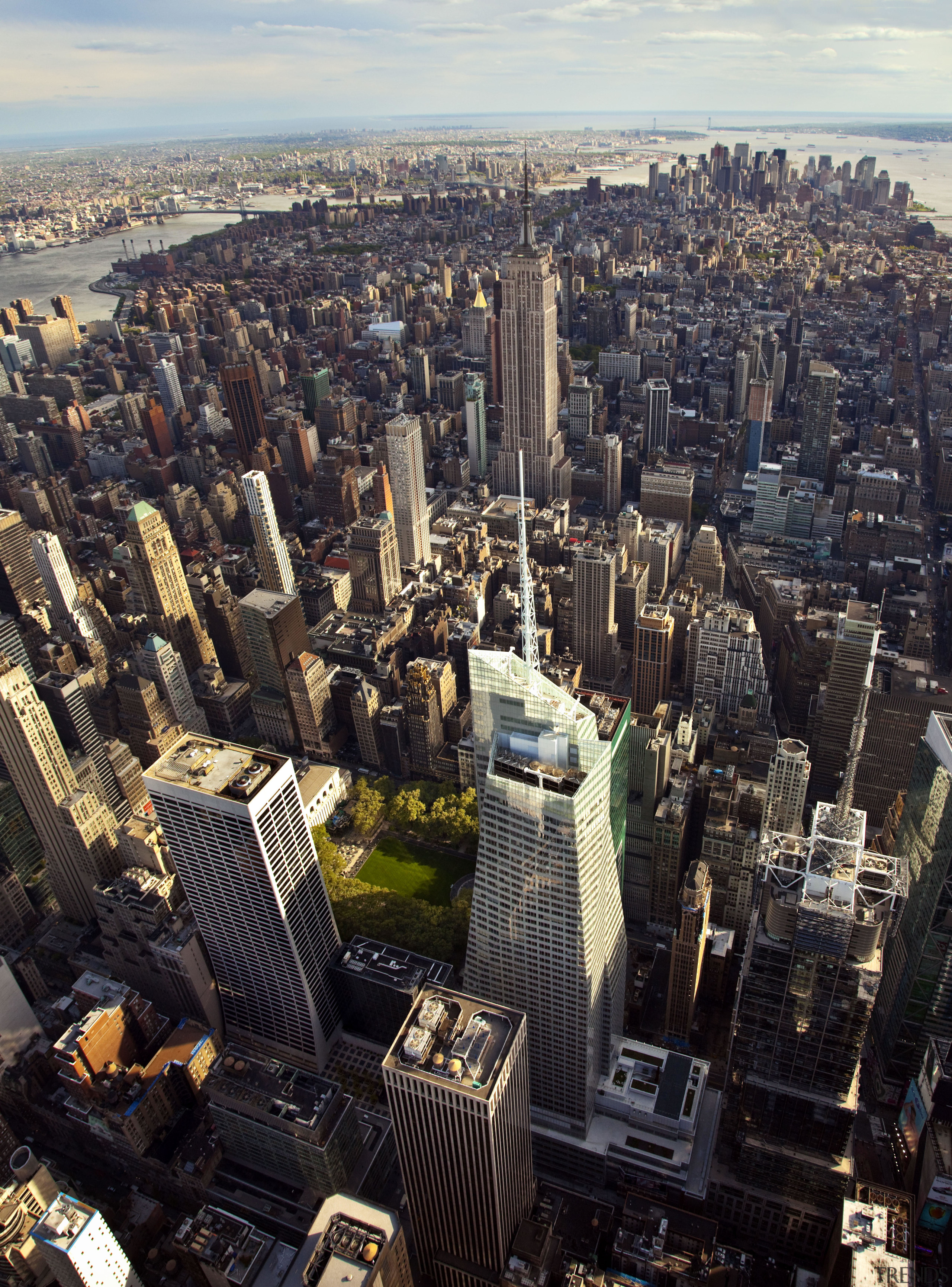 View of the Bank of America Tower in aerial photography, bird's eye view, building, city, cityscape, daytime, downtown, landmark, metropolis, metropolitan area, sky, skyline, skyscraper, tower, tower block, urban area, black, gray