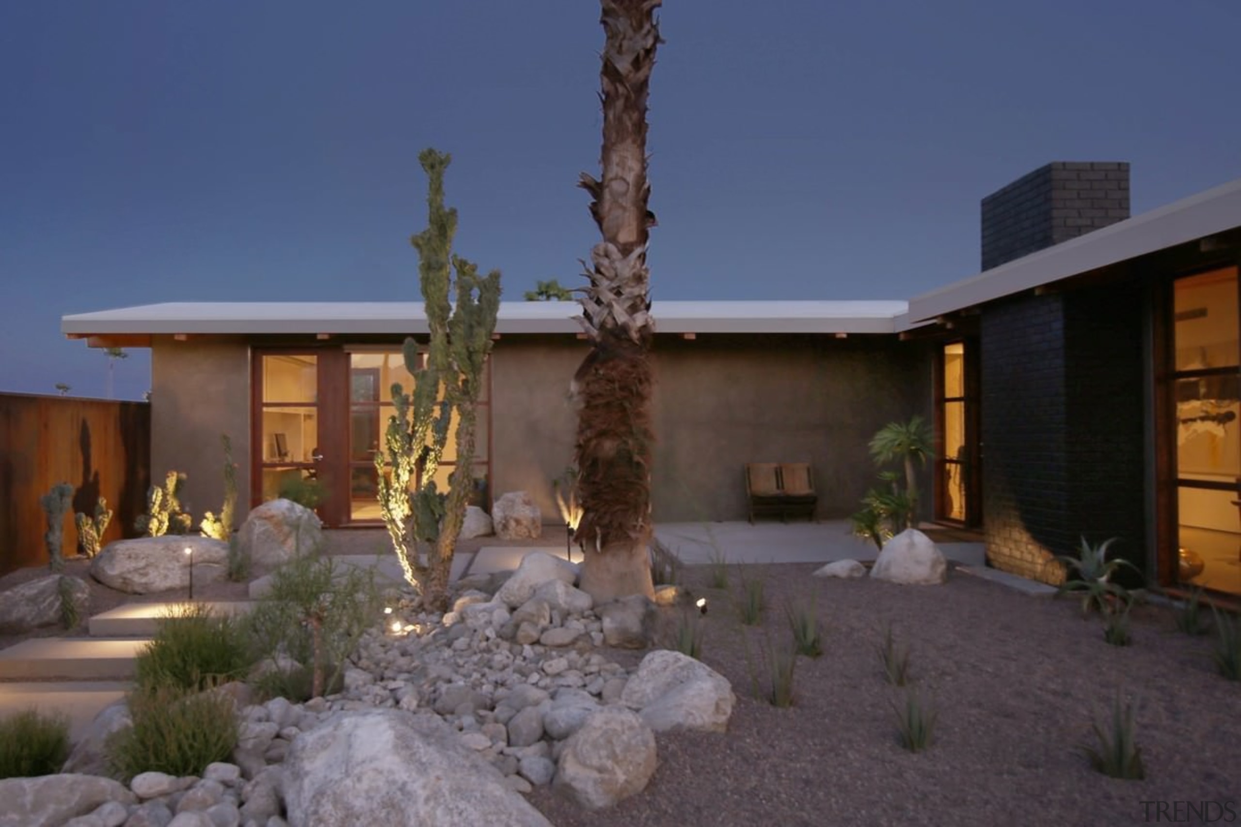 A view of the home at night - architecture, backyard, courtyard, estate, facade, home, house, landscape, lighting, property, real estate, residential area, blue, black