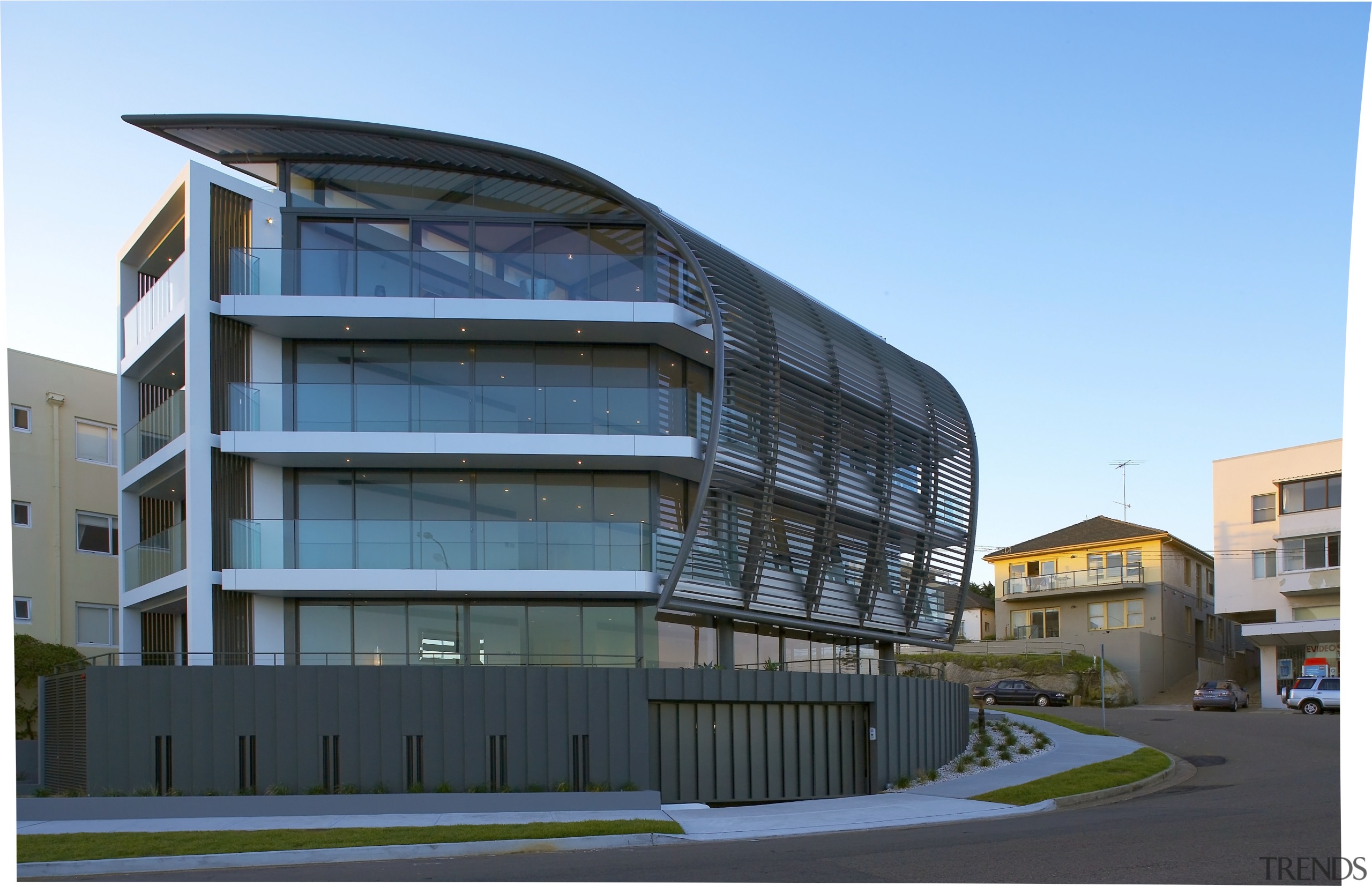 Exterior view of a Sydney apartment building which apartment, architecture, building, commercial building, condominium, corporate headquarters, facade, headquarters, house, metropolitan area, mixed use, property, real estate, residential area, sky, teal, black