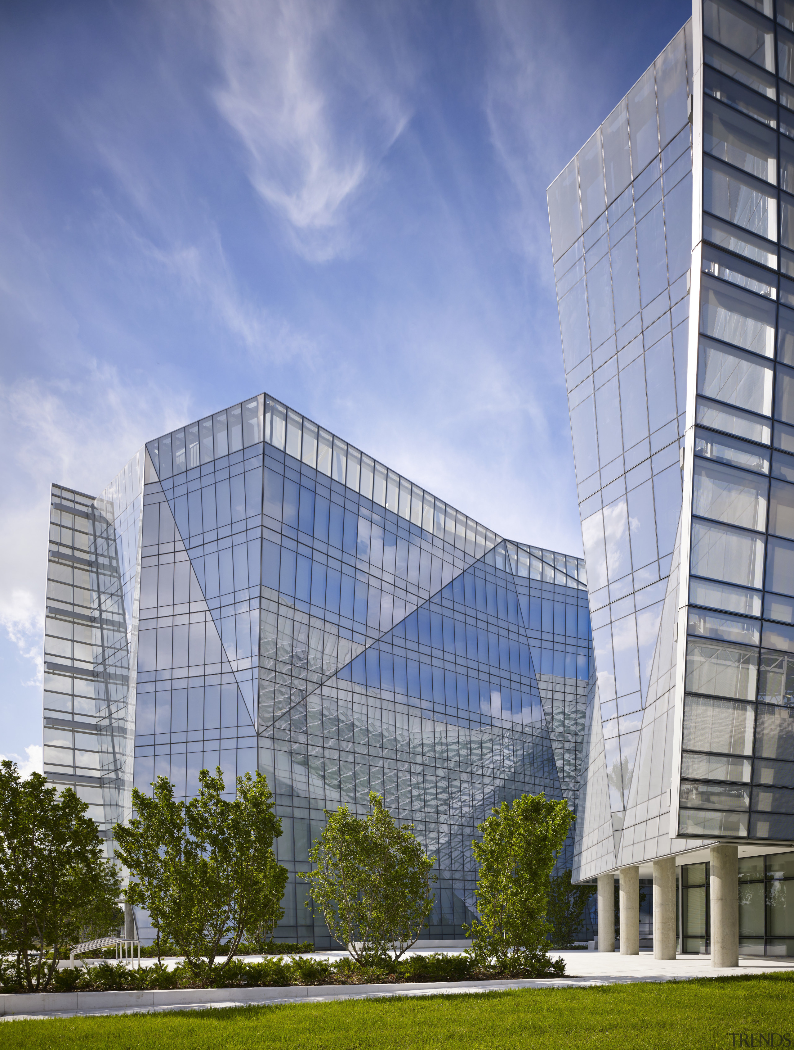The facade on the new FBI headquarters changes architecture, building, city, commercial building, condominium, corporate headquarters, daytime, facade, headquarters, landmark, metropolis, metropolitan area, mixed use, real estate, reflection, sky, skyscraper, tower block, urban area, teal
