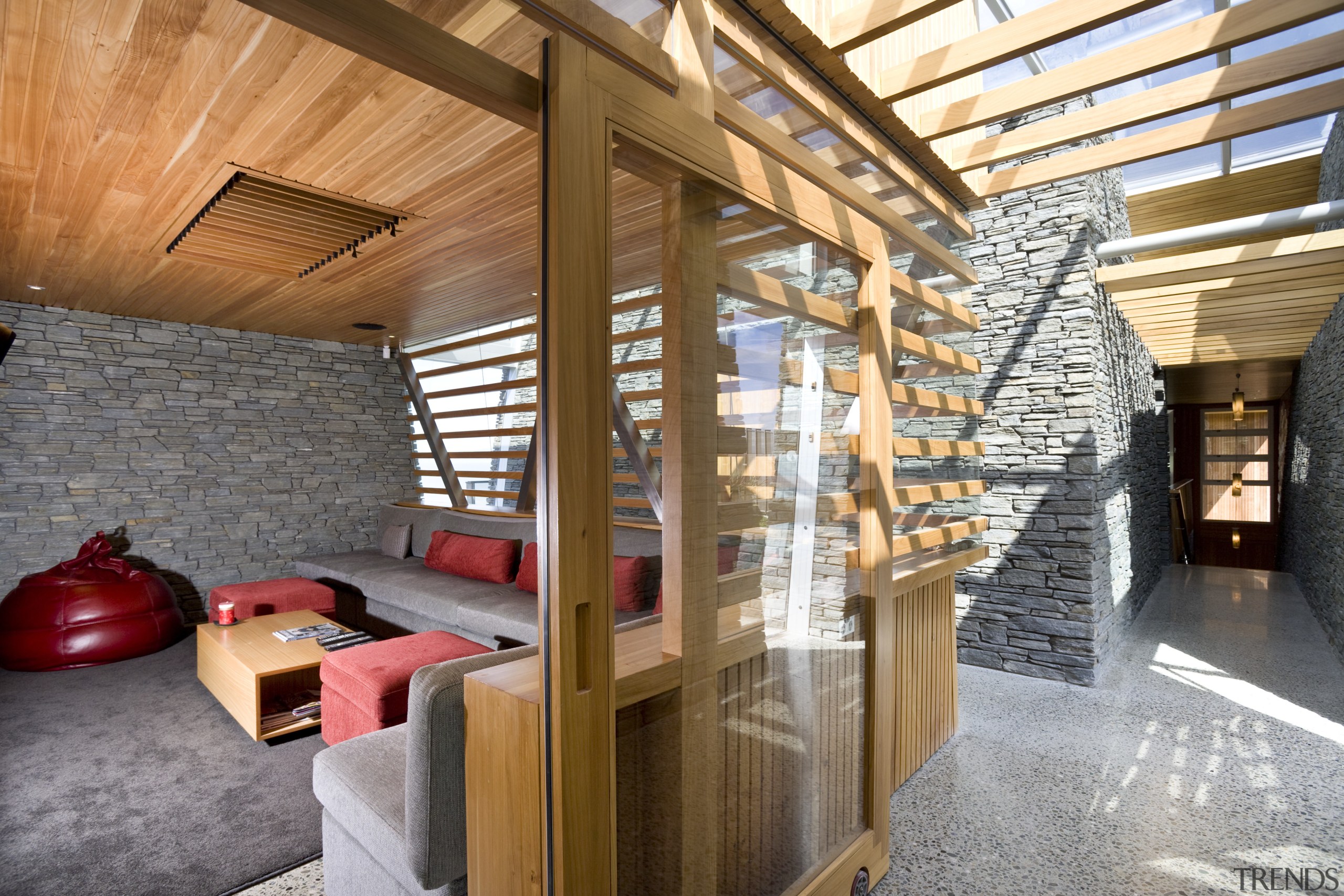 View of the media room featuring couches and architecture, ceiling, interior design, loft, real estate, wood, brown, gray