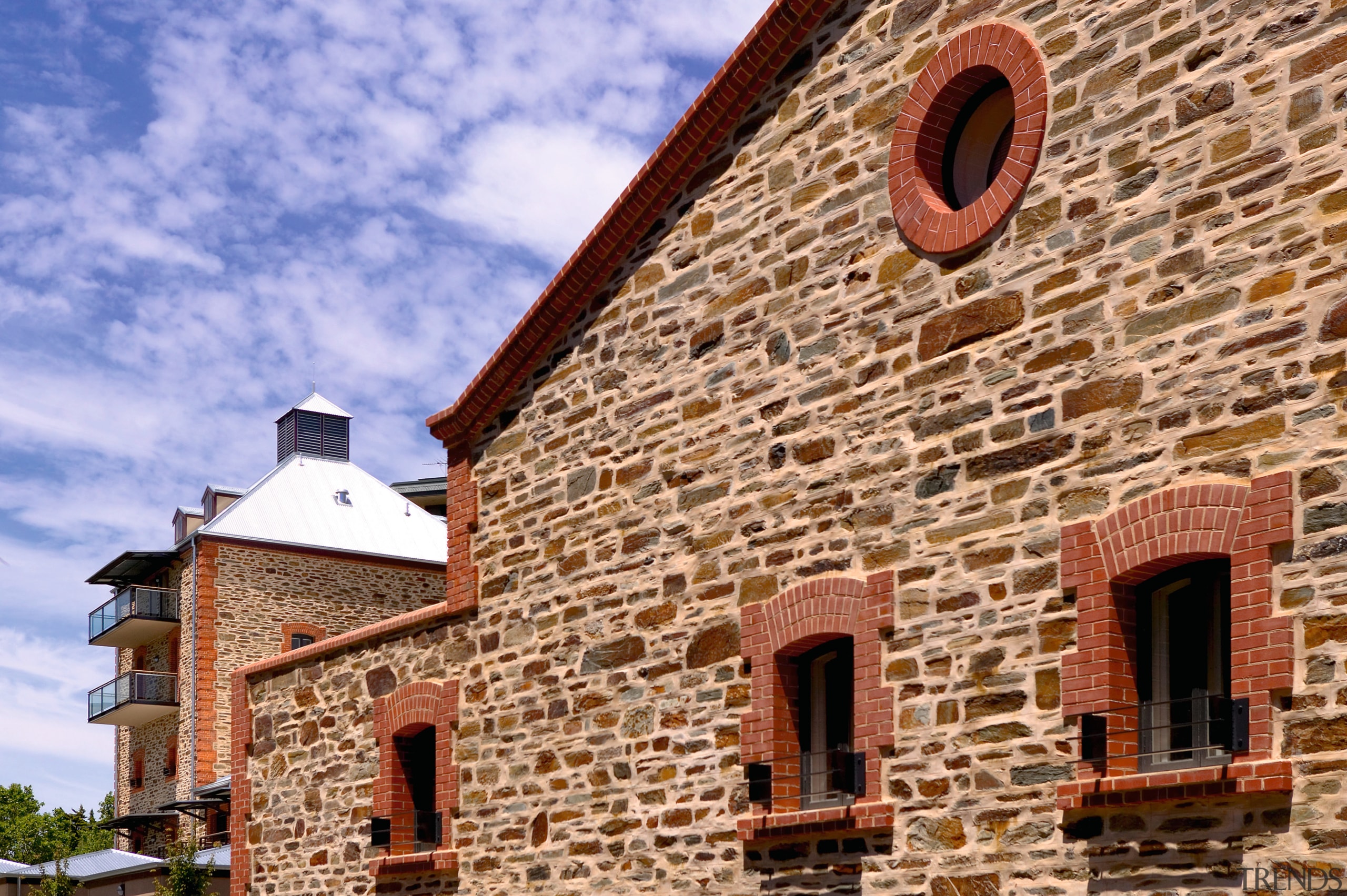 Apartment complex with original bluestone walls, red brick brick, brickwork, building, facade, historic site, medieval architecture, property, roof, sky, wall, window, brown, blue