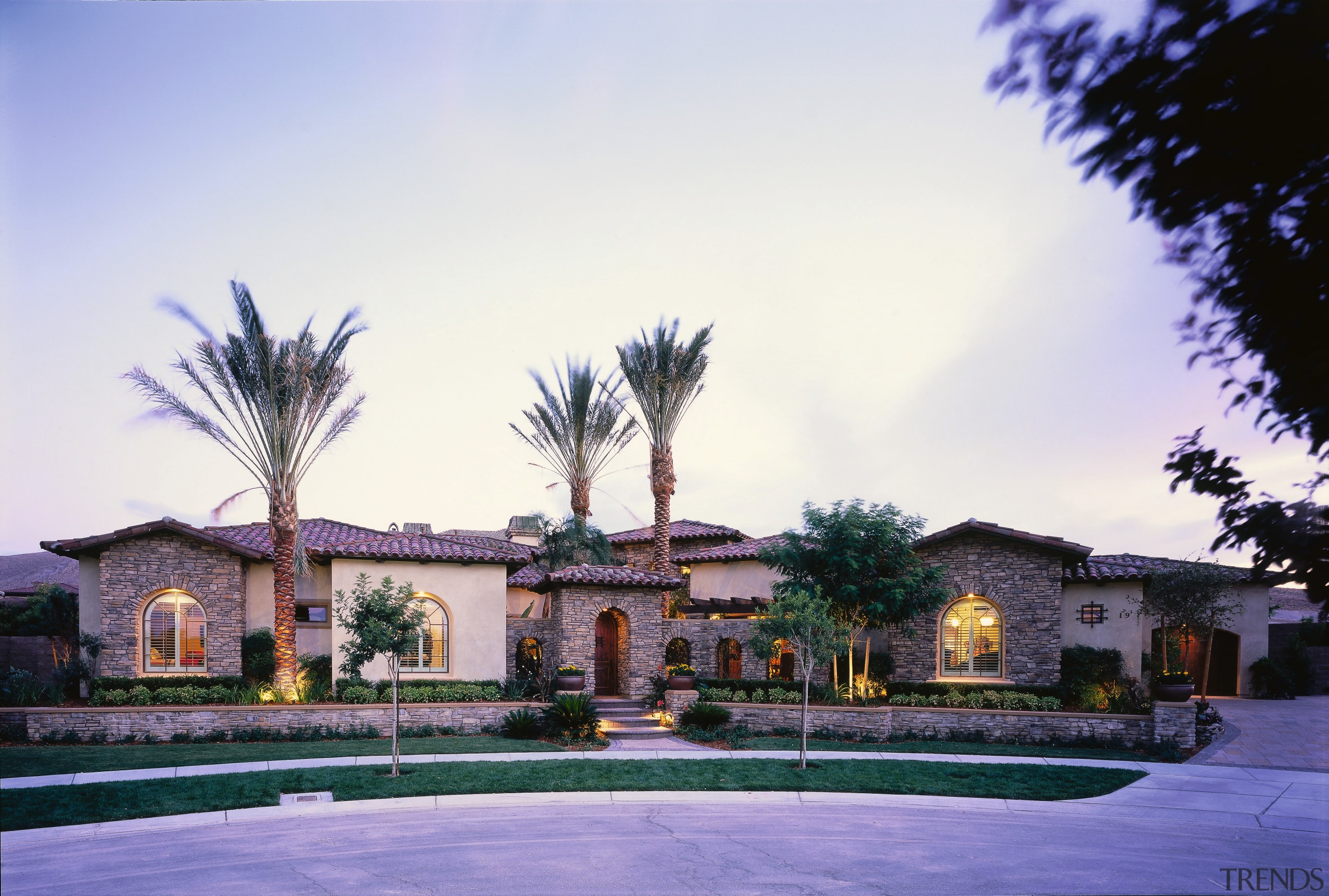 view of the mediteranean house  showing stone arecales, estate, hacienda, home, house, mansion, palm tree, property, real estate, residential area, resort, sky, tree, villa, white