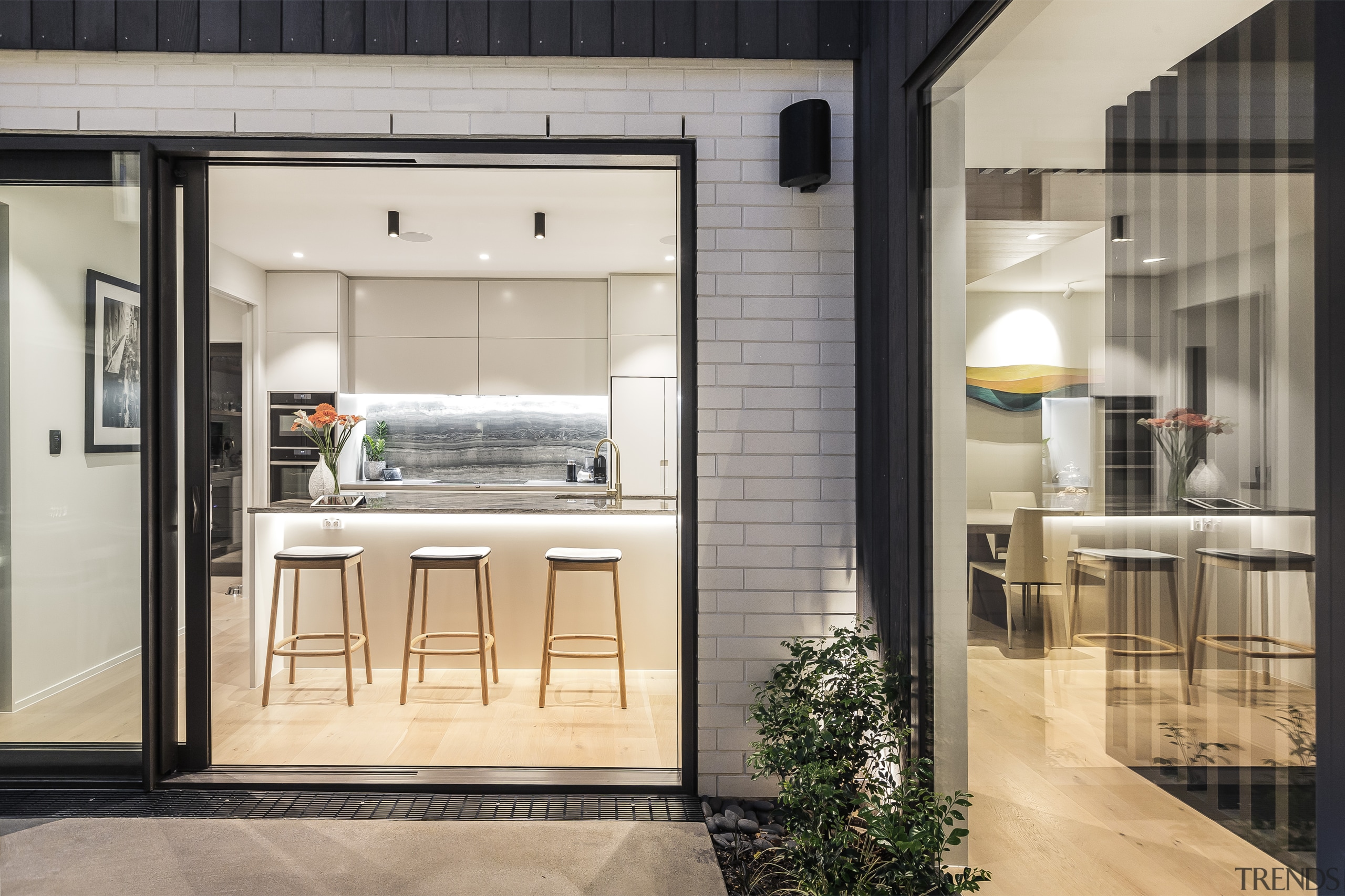 The well-appointed kitchen has a feature splashback and 