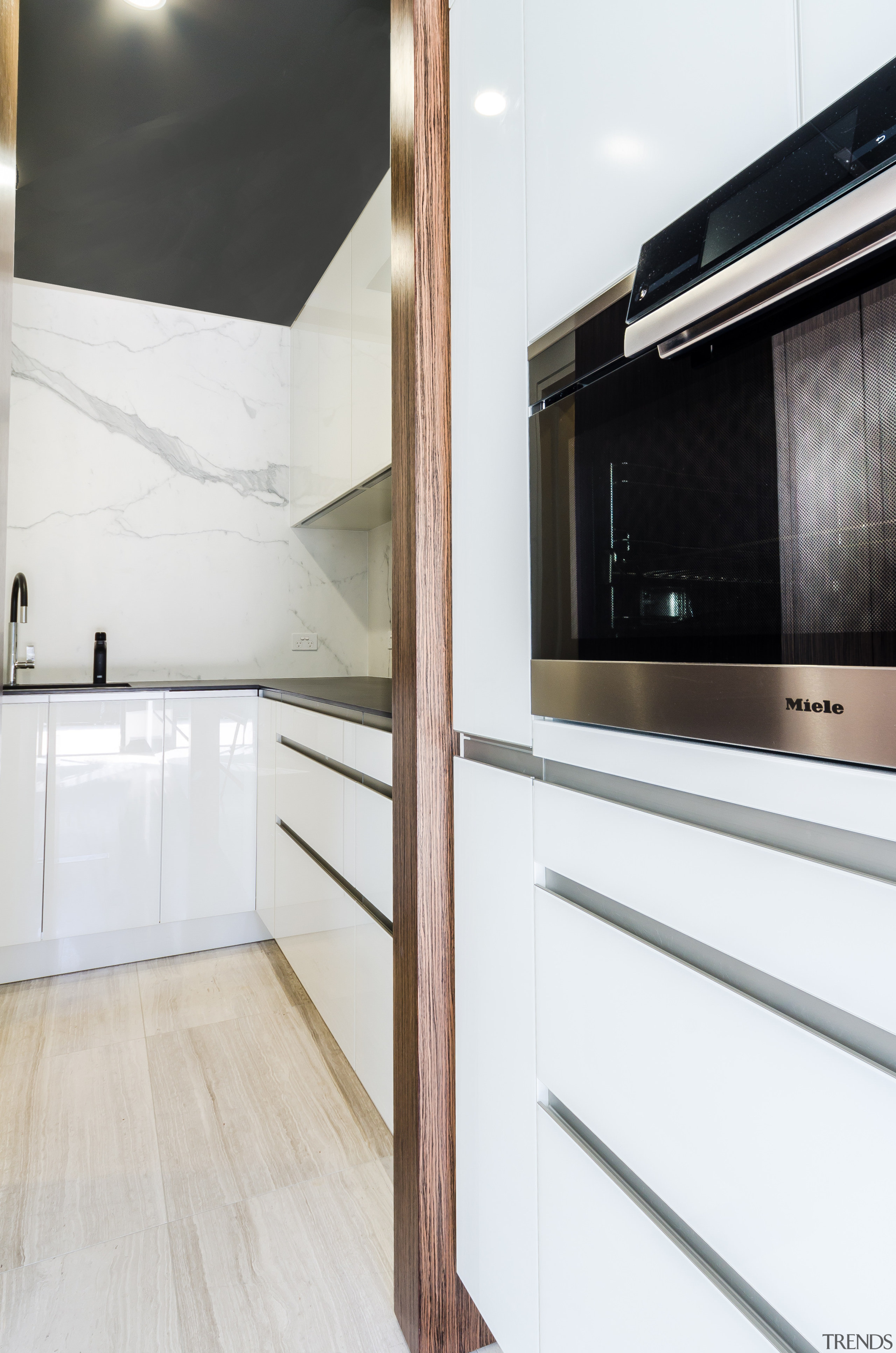 This kitchens white glass perimeter cabinetry and stone-look cabinetry, countertop, cuisine classique, floor, home appliance, interior design, kitchen, property, room, white