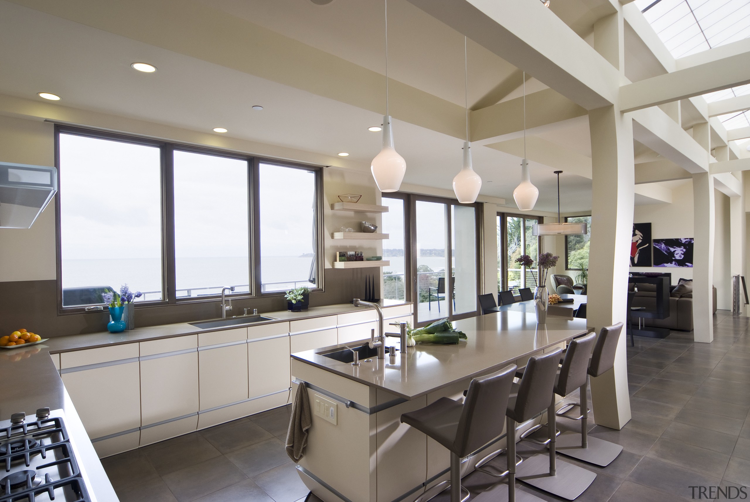 View of neutral-toned kitchen and dining space, featuring countertop, interior design, kitchen, property, real estate, window, gray