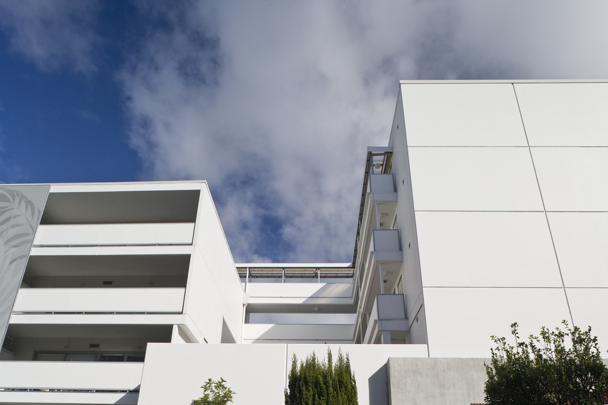 Exterior view of the Ivory apartments which features architecture, building, condominium, corporate headquarters, daylighting, daytime, elevation, facade, house, real estate, residential area, sky, white, gray