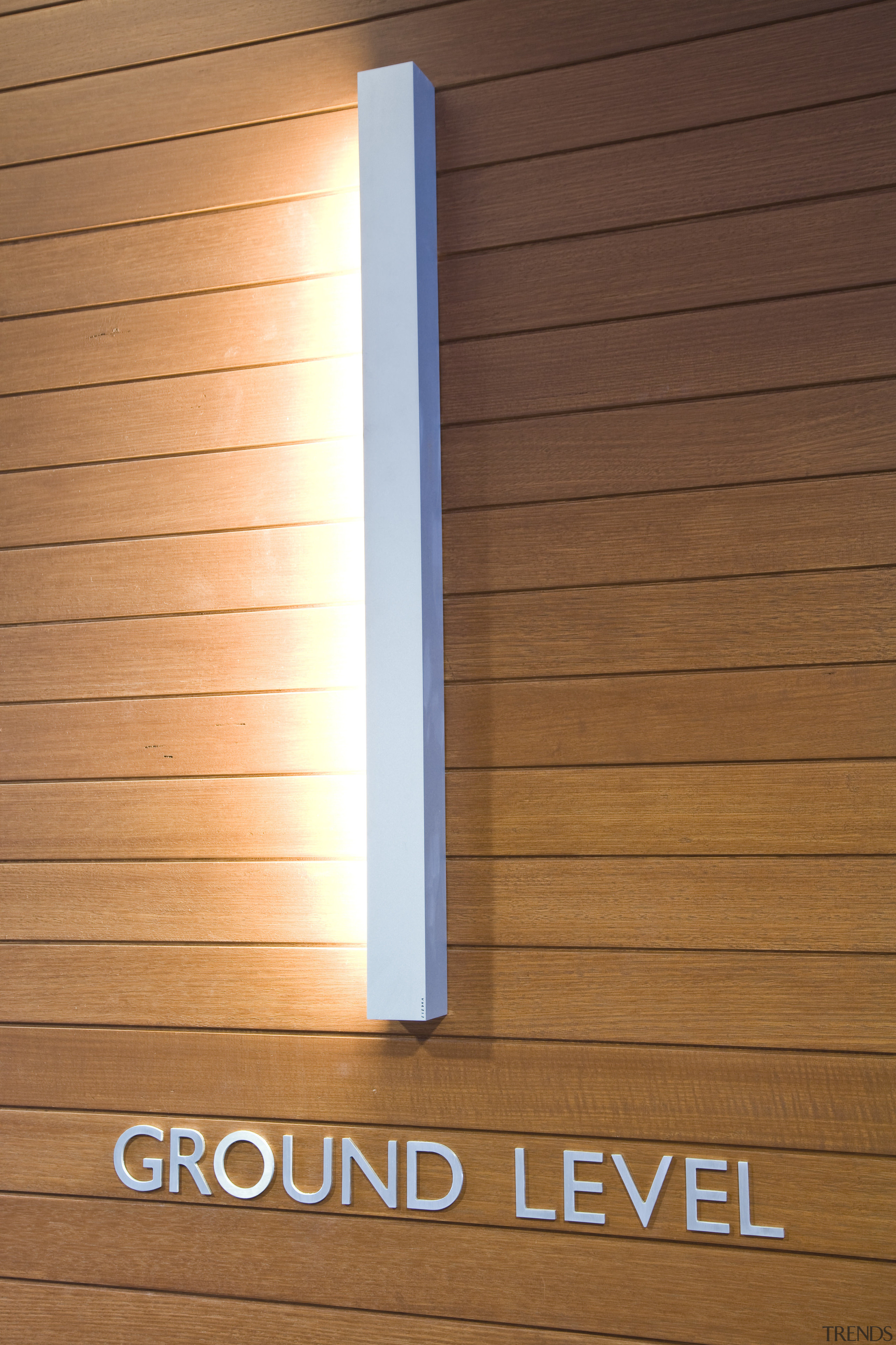 Interior view of the Quest Hotel where they angle, heat, light, lighting, wall, wood, wood stain, brown, orange