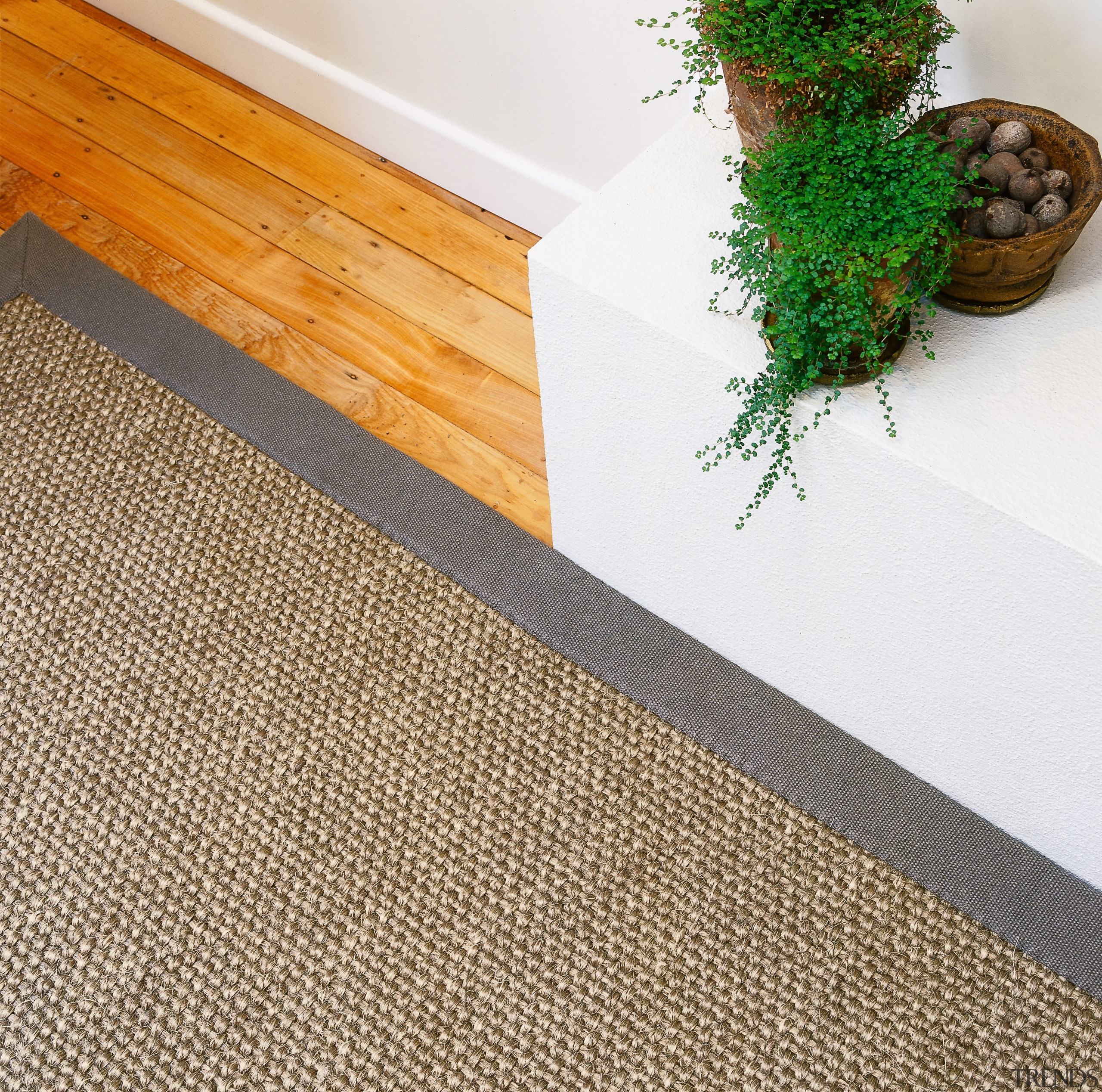 Closeup view of sisal rug on timber floor. floor, flooring, hardwood, tile, wood, wood stain, white, brown