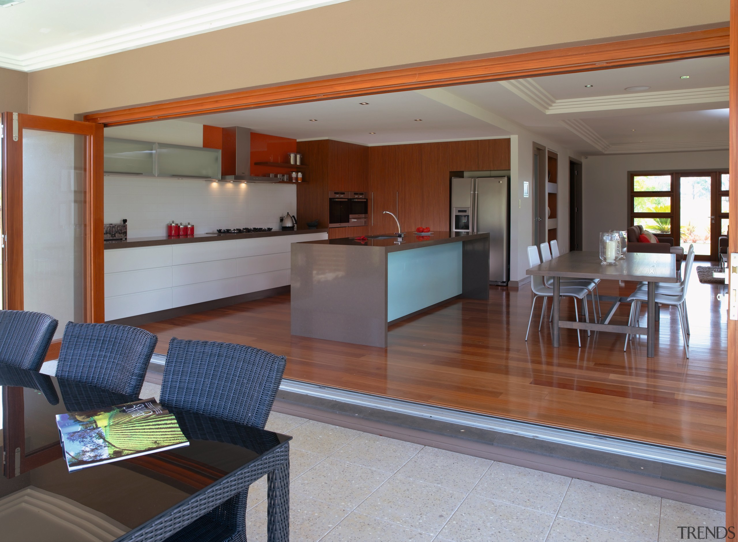 View of this kitchen featuring timber laminate flooring, floor, flooring, house, interior design, living room, property, real estate, window, gray, brown