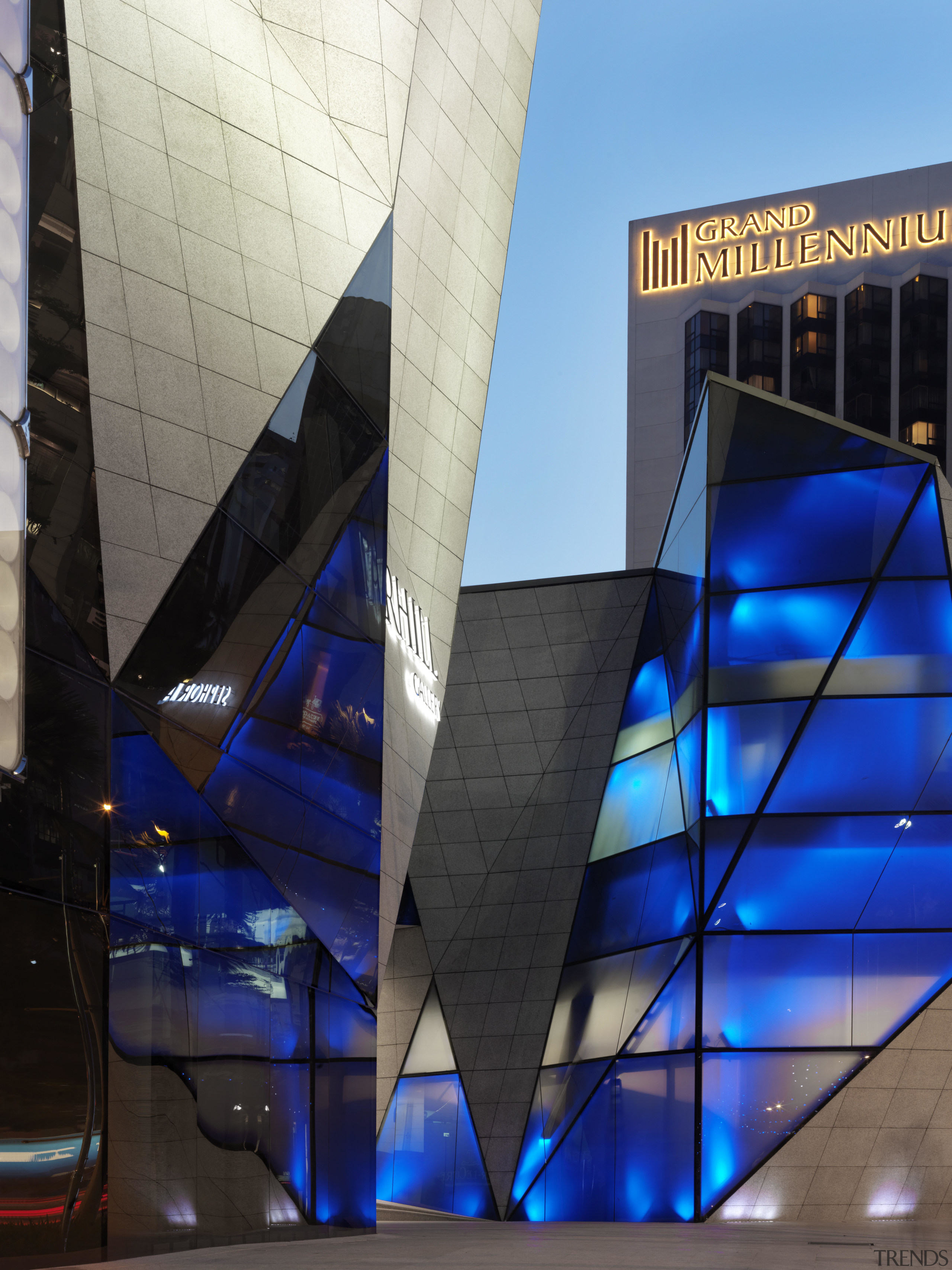 View of exterior at dusk. - View of architecture, blue, building, corporate headquarters, daylighting, daytime, facade, glass, metropolis, metropolitan area, reflection, skyscraper, structure, blue