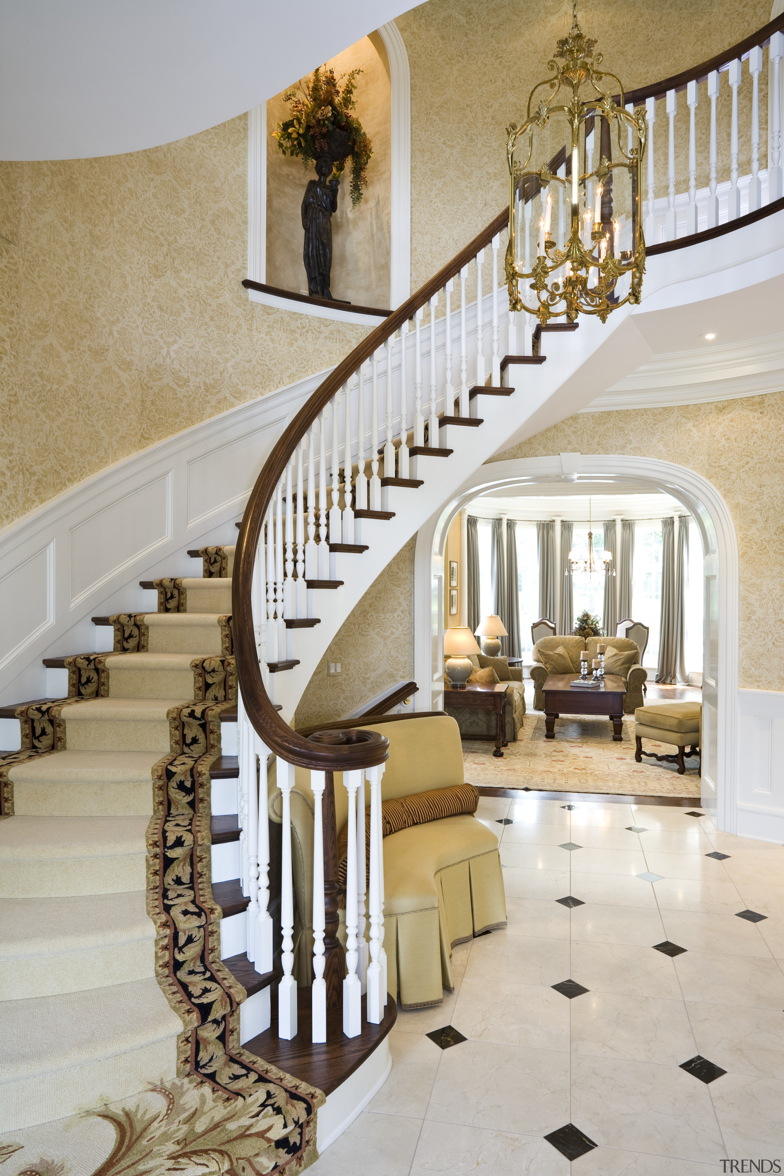 View of a sweeping staircase with dark-stained timber baluster, estate, floor, flooring, handrail, home, interior design, stairs, gray