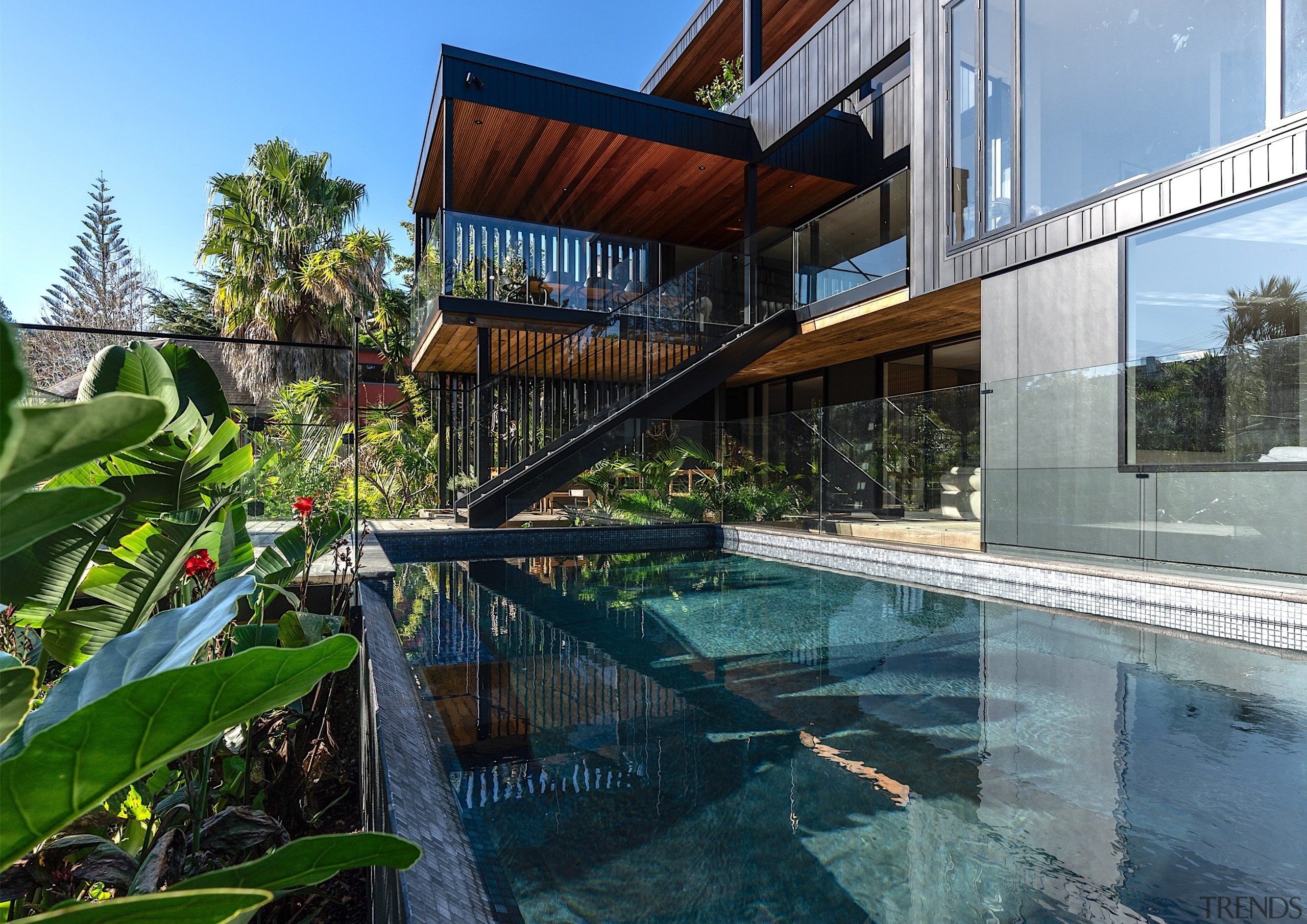 The home's striking rear architecture reflected in the 