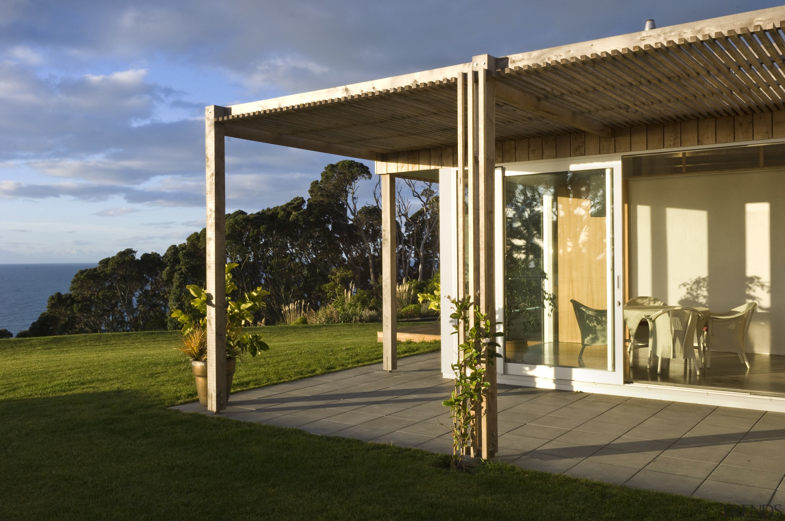 Exterior view of a covered patio area with home, house, outdoor structure, pergola, porch, real estate, brown