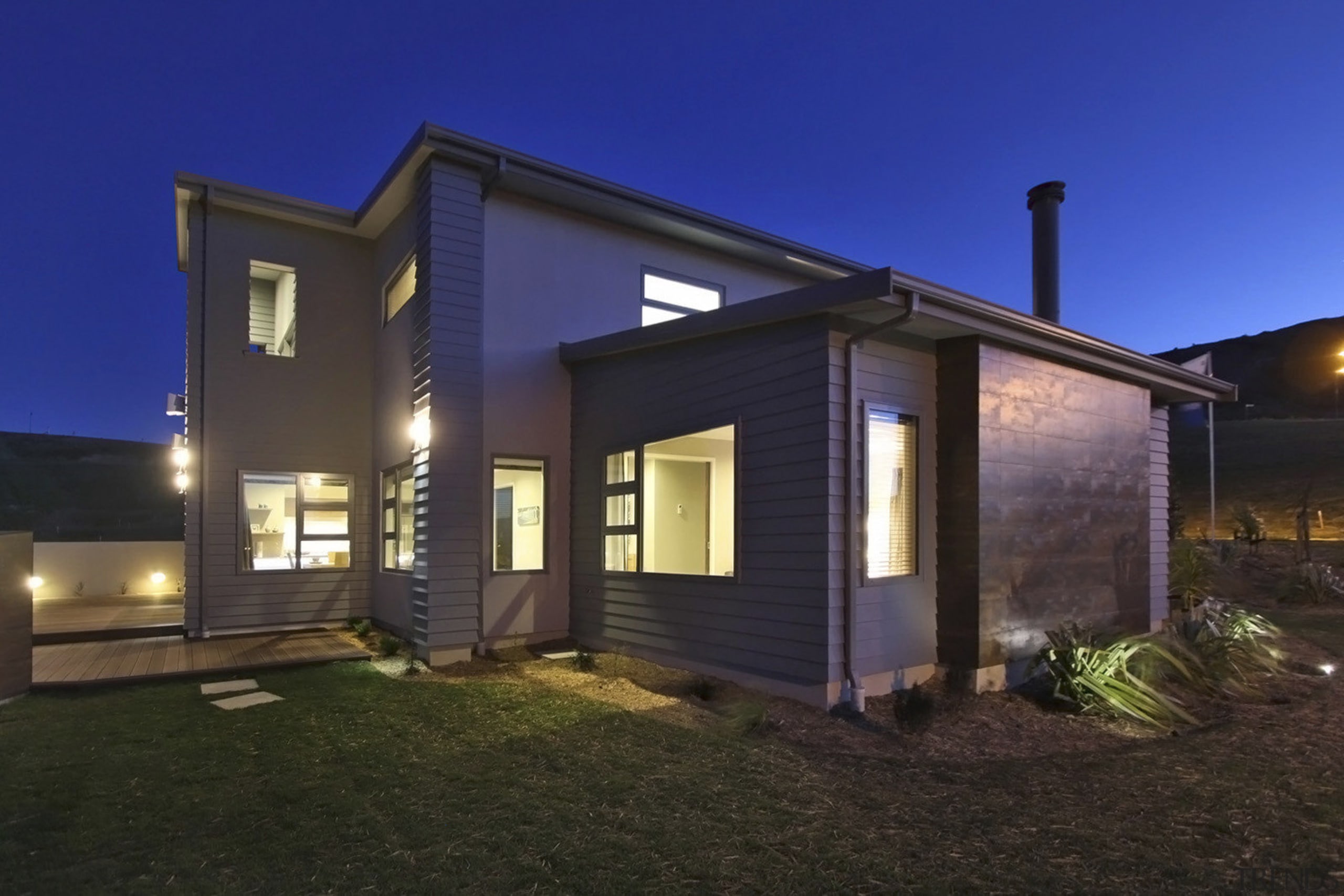 Exterior view of an energy-efficient home designed and cottage, estate, facade, home, house, lighting, property, real estate, residential area, siding, window, black, blue