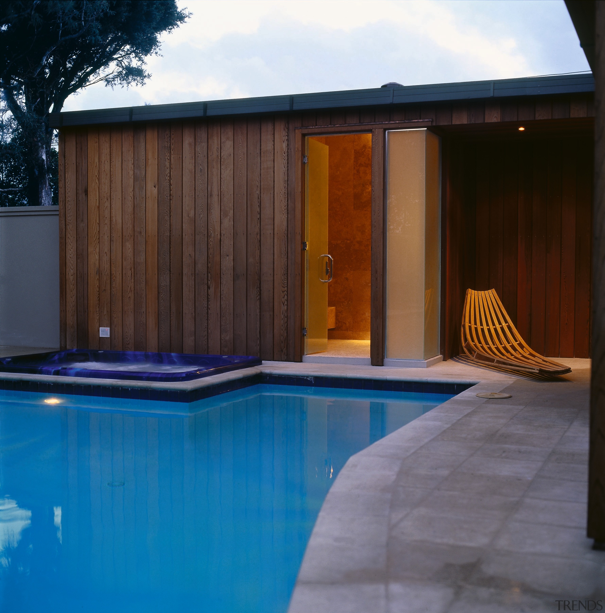 The view of a home overlooking a pool architecture, facade, home, house, lighting, property, real estate, reflection, swimming pool, wood, black