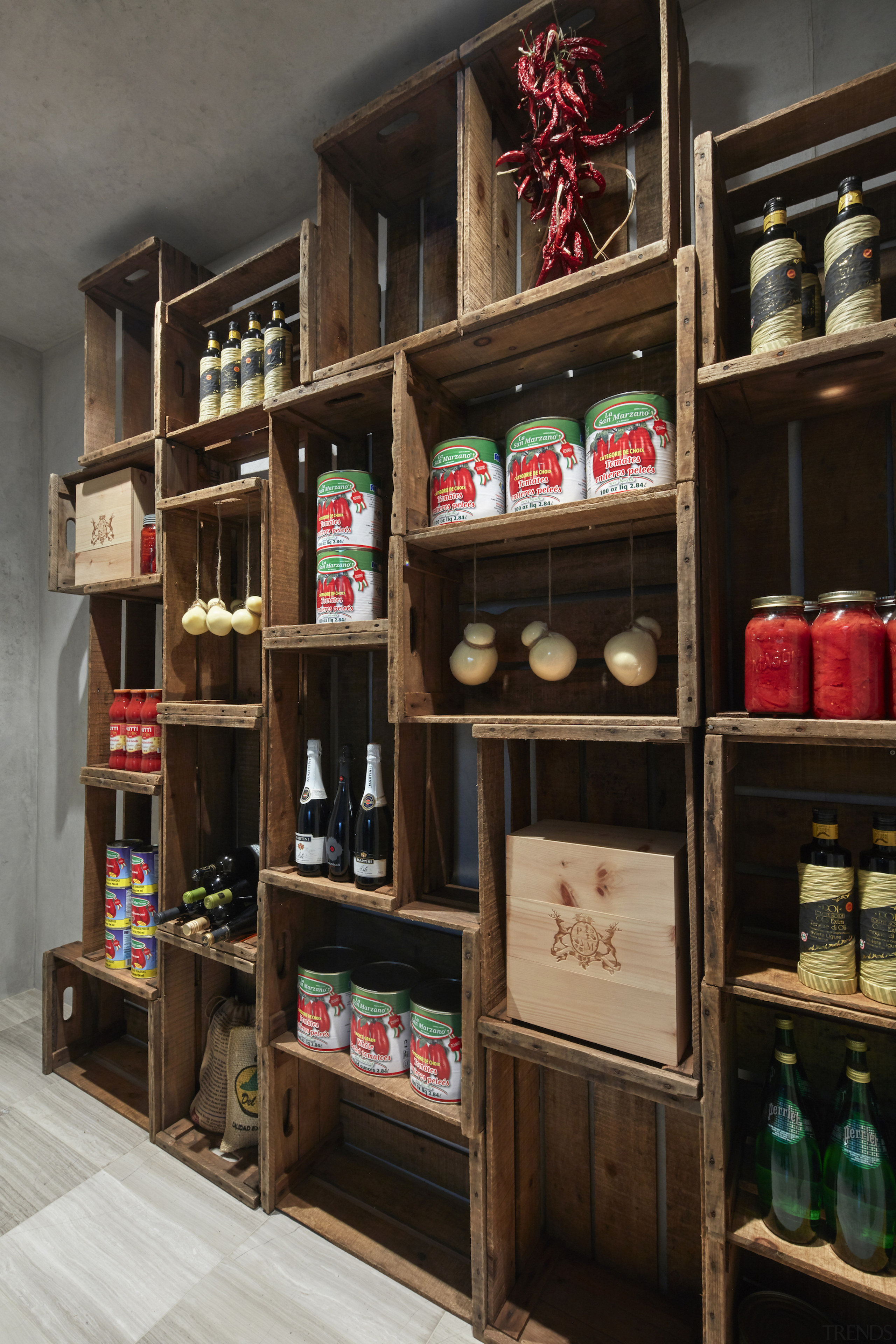 The pantry, clad in timber board, divides the 