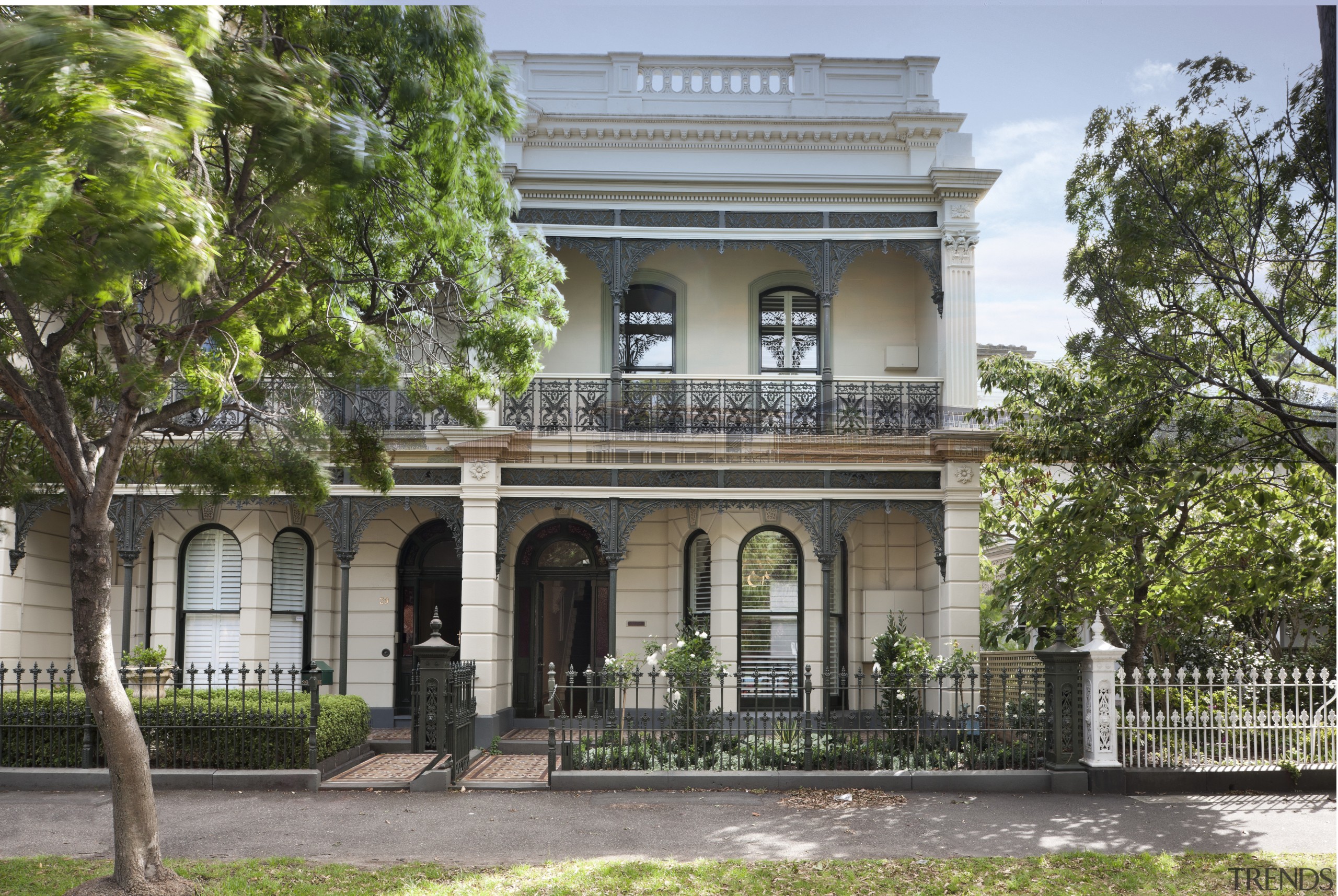 Exterior with intricate detailing and rounded windows. building, classical architecture, estate, facade, historic house, historic site, home, house, mansion, official residence, property, real estate, tree, villa, gray, brown