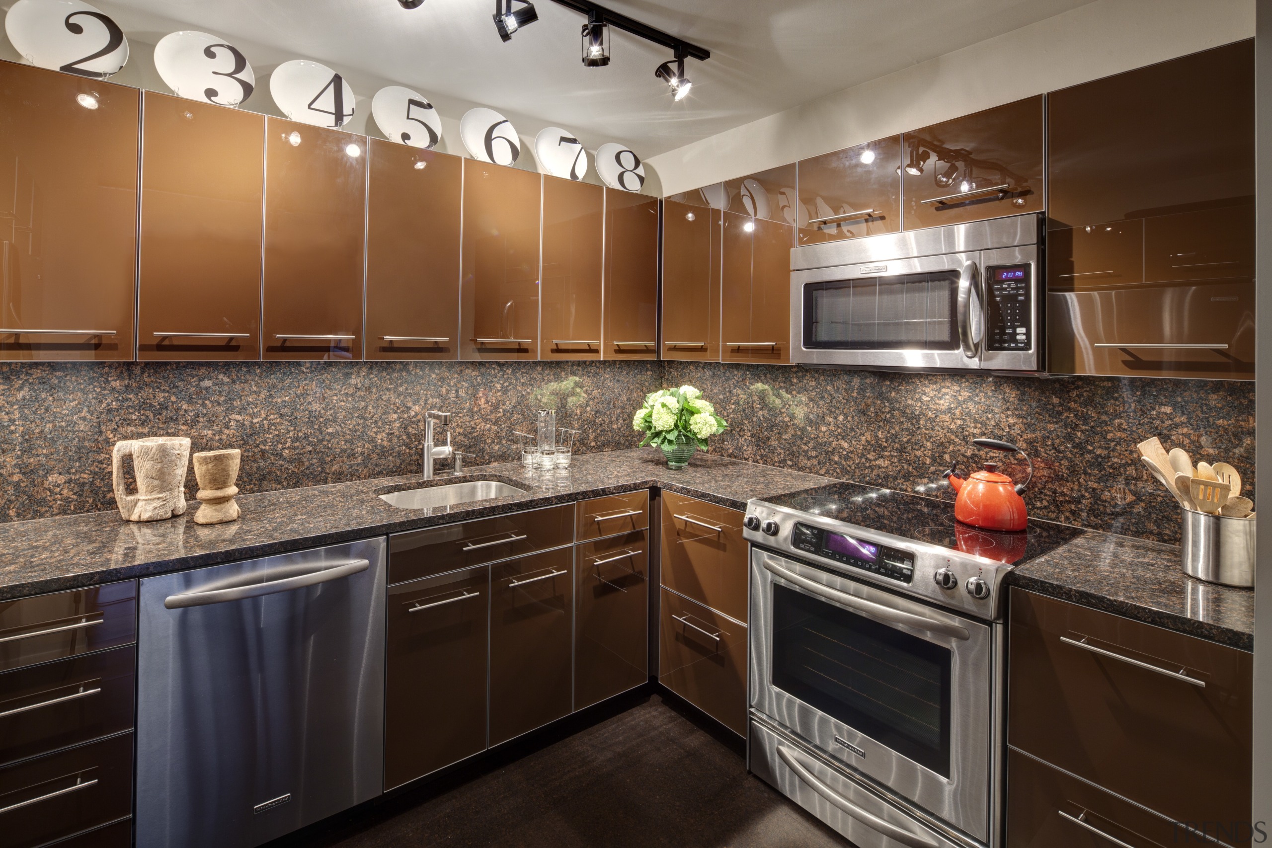 Contemporary apartment kitchen with reflective cabinetry and brown cabinetry, countertop, cuisine classique, flooring, hardwood, home, interior design, kitchen, room, under cabinet lighting, brown, gray