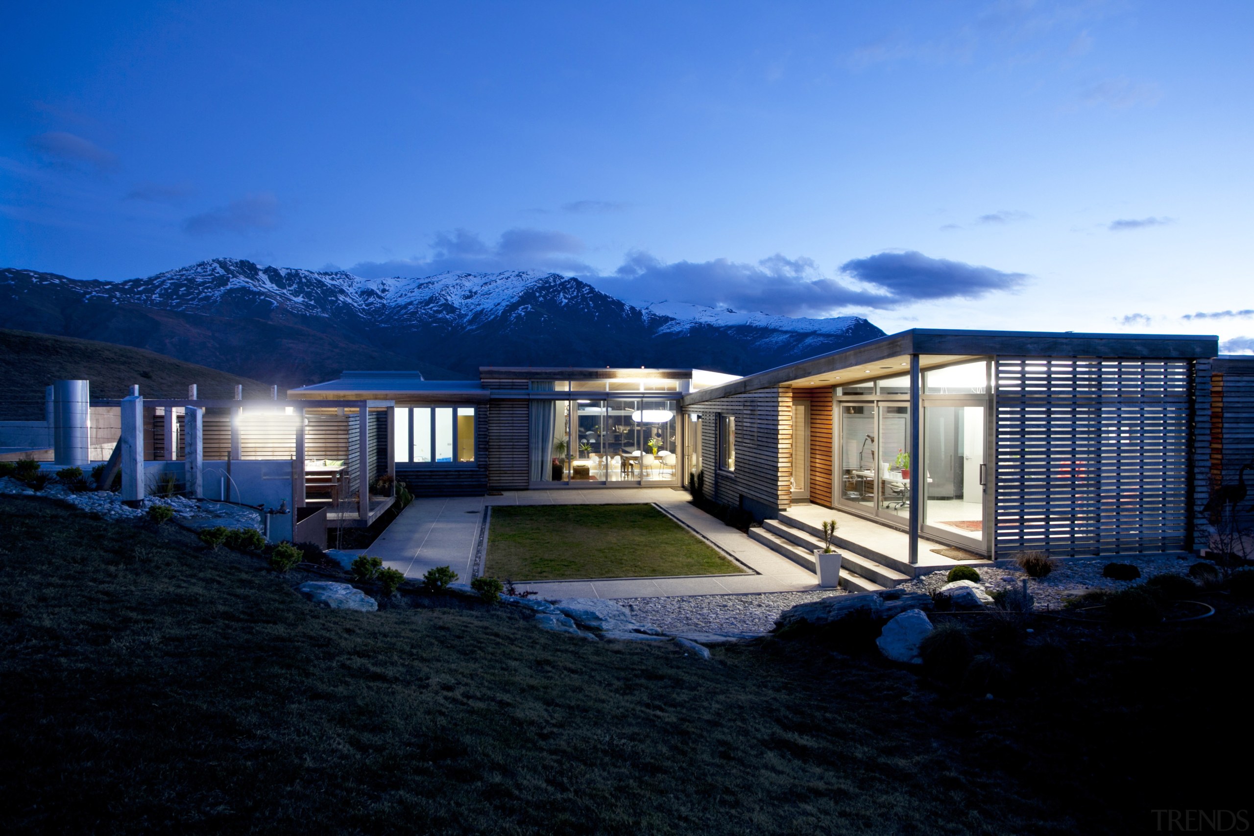 This home was designed by architect Nick Karlovsky. architecture, building, cloud, estate, home, house, lighting, property, real estate, reflection, residential area, roof, sky, water, black, blue