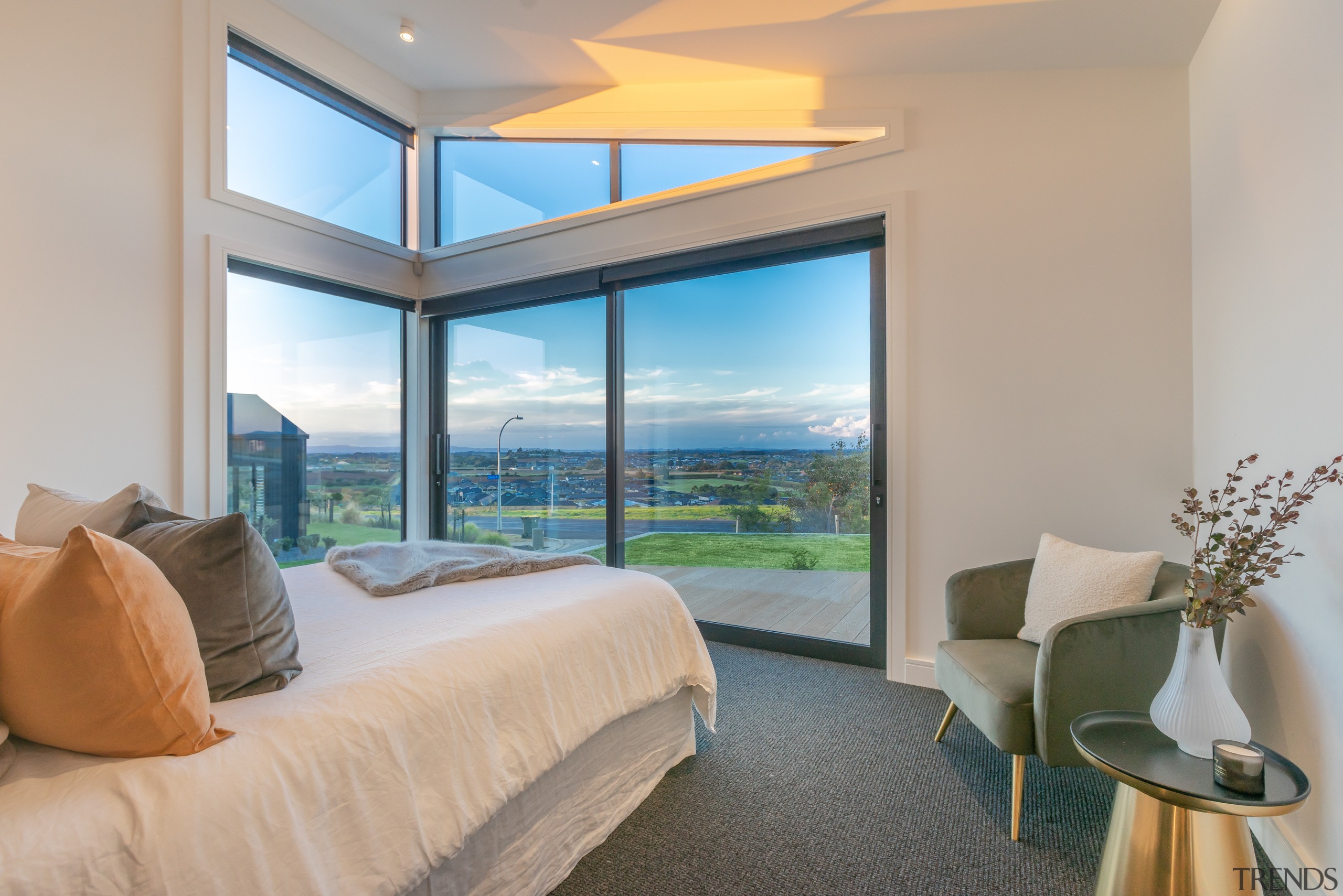 Light-filled master bedroom showing corner and clerestory windows. 