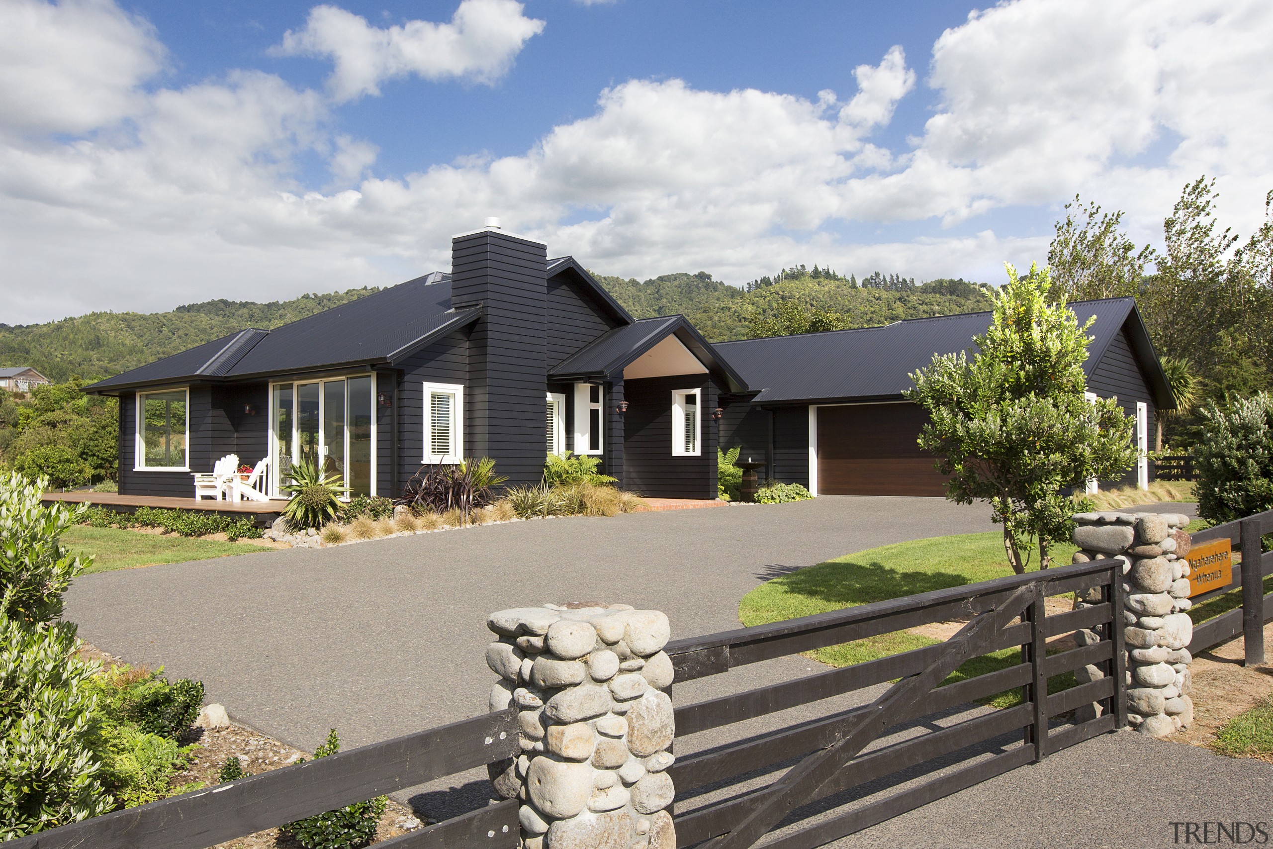 With its black weatherboards, sofites and roof this cottage, elevation, estate, facade, farmhouse, home, house, land lot, landscape, property, real estate, residential area, gray, white