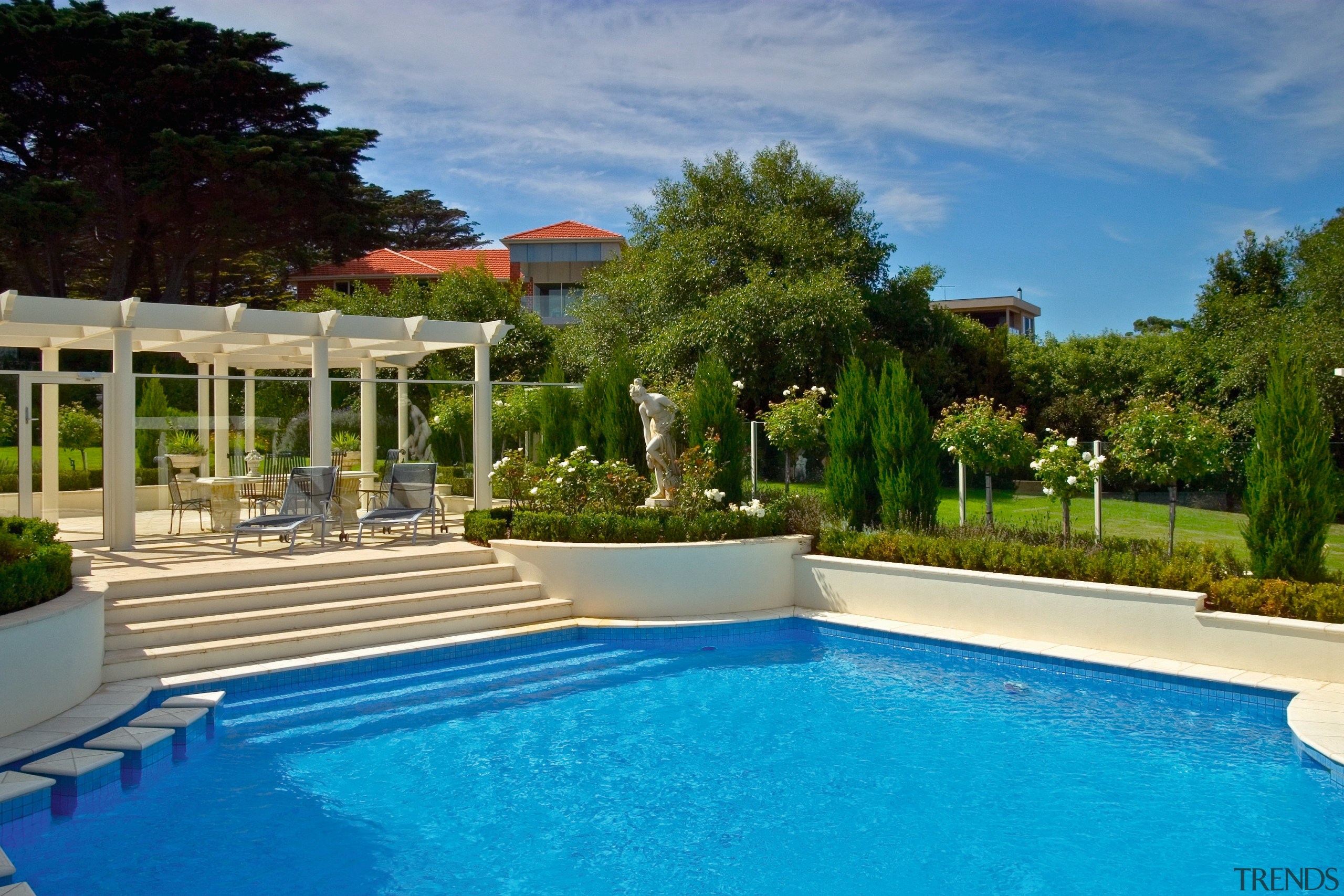 View of the poolside - View of the backyard, cottage, estate, home, house, landscaping, leisure, outdoor structure, property, real estate, resort, swimming pool, villa, teal