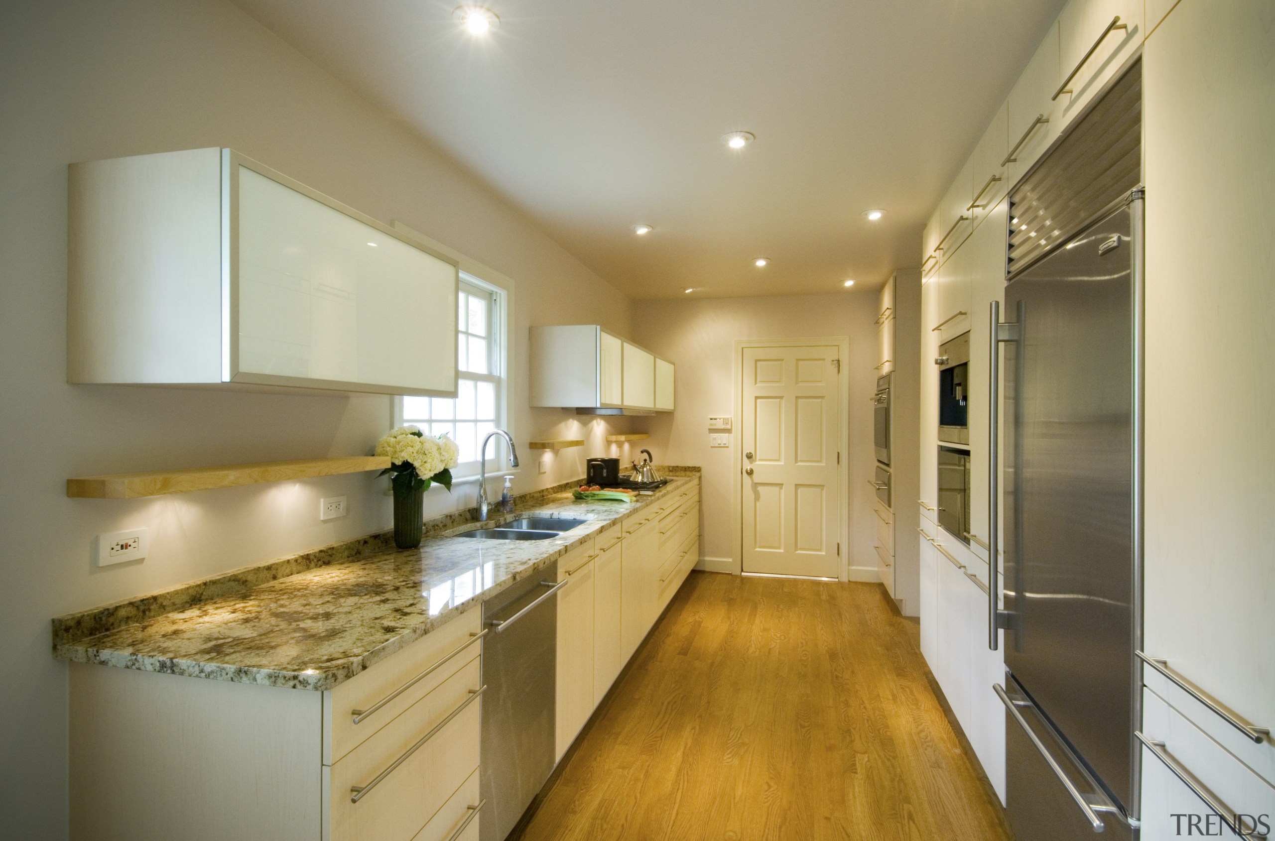 A view of this minimalist clean lined kitchen cabinetry, ceiling, countertop, cuisine classique, interior design, kitchen, real estate, room, brown, orange