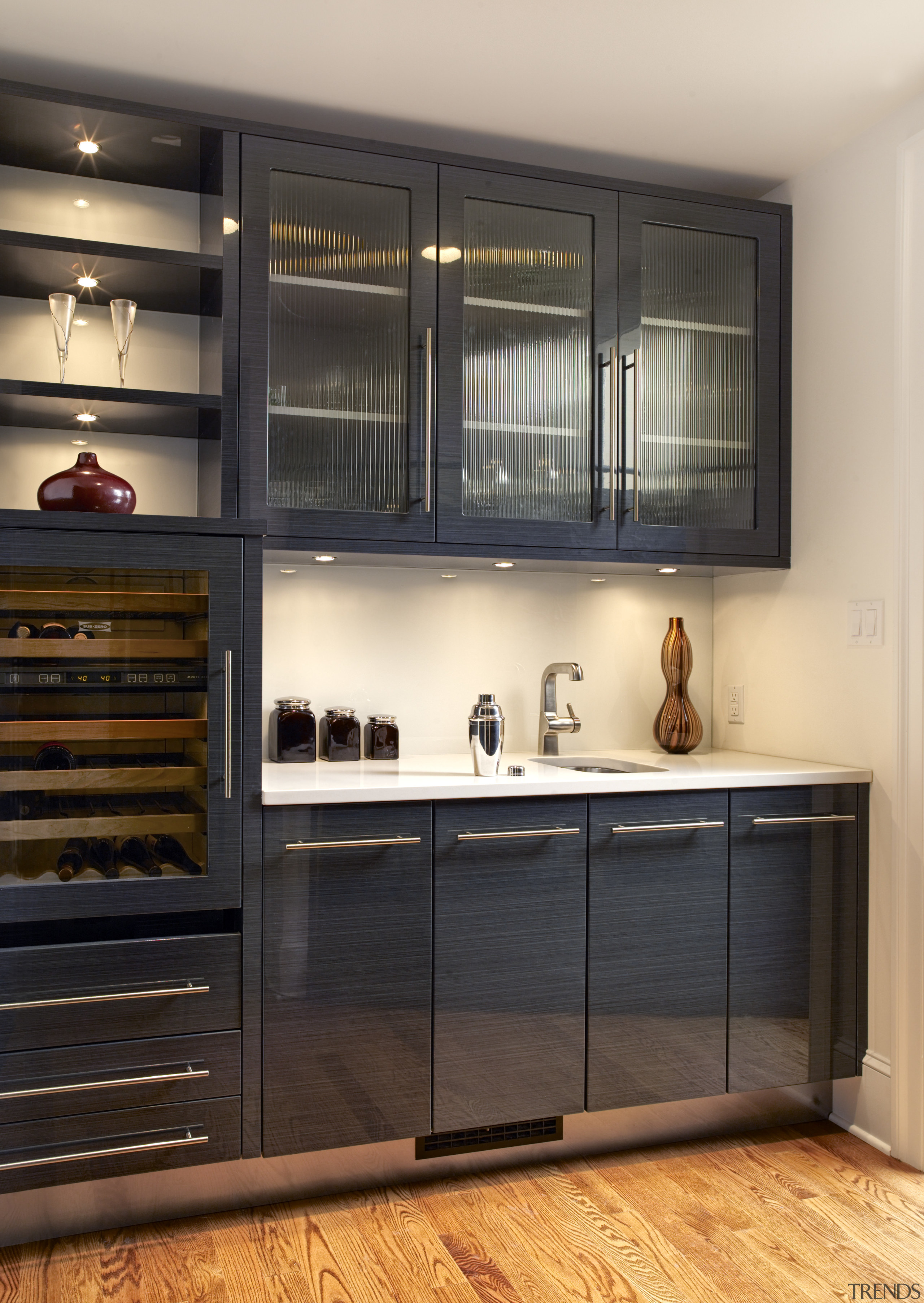 View of a kitchen which features kitchen cabinetry cabinetry, countertop, cuisine classique, interior design, kitchen, shelf, shelving, under cabinet lighting, black, orange