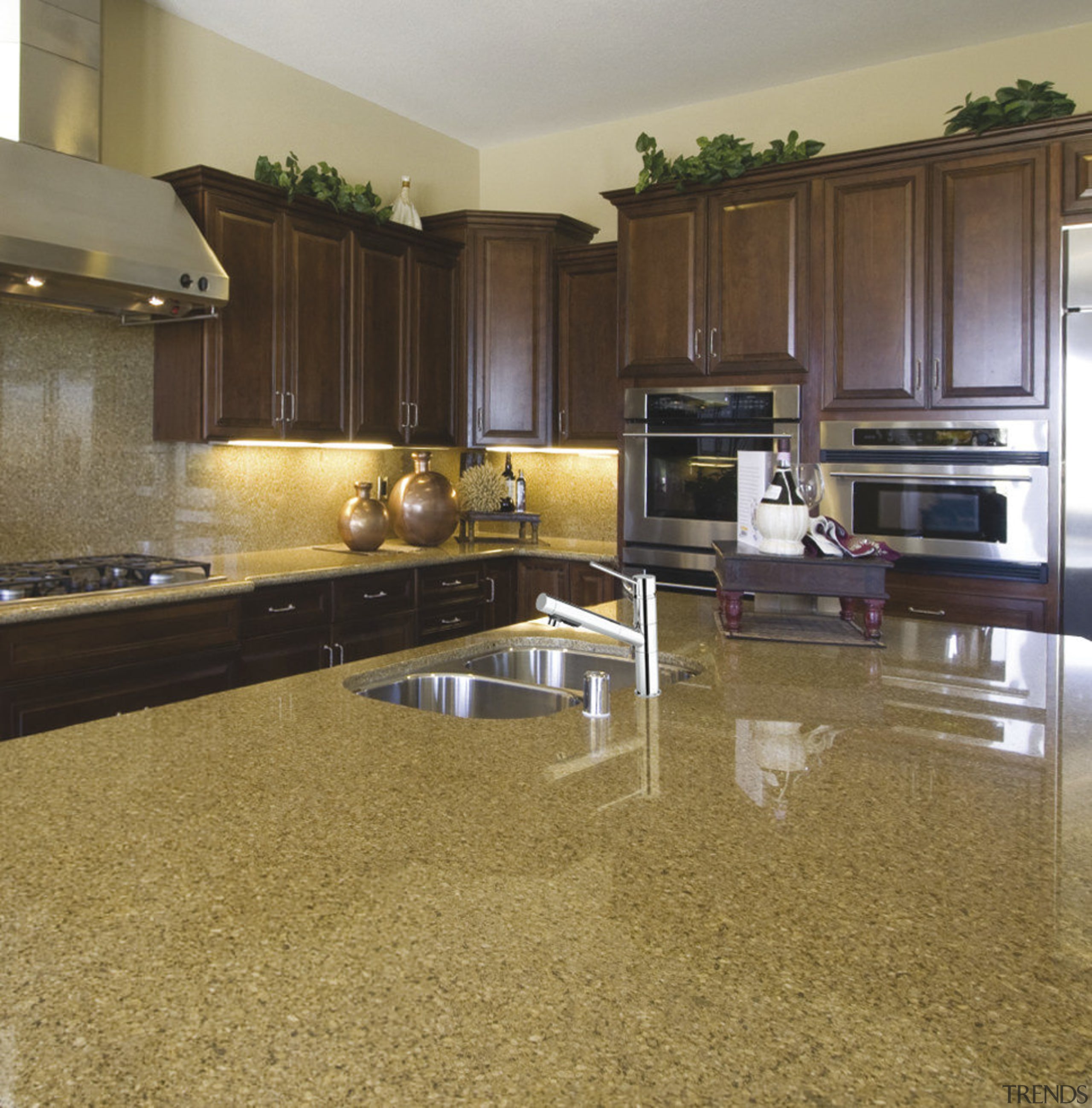 View of a kitchen which features a stainless countertop, floor, flooring, hardwood, interior design, kitchen, laminate flooring, wood flooring, brown