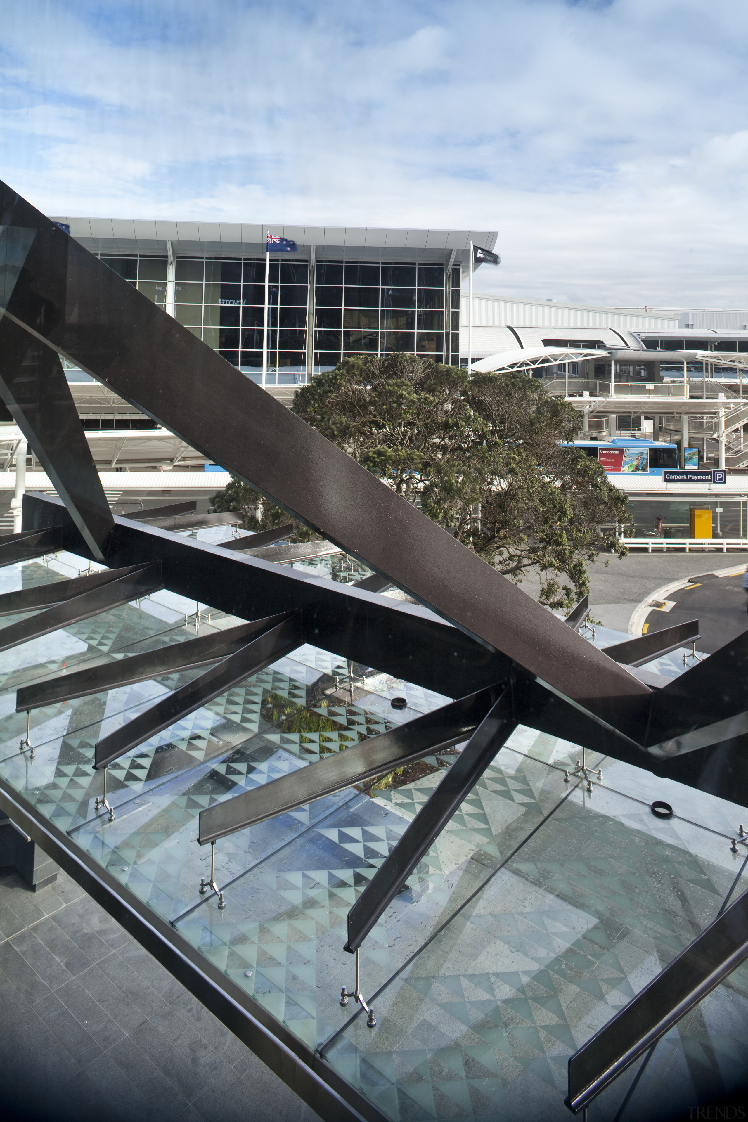 Novotel Auckland Airport by Gorge Grant Engineering. architecture, building, condominium, daylighting, reflection, roof, sky, structure, water, black, gray, white