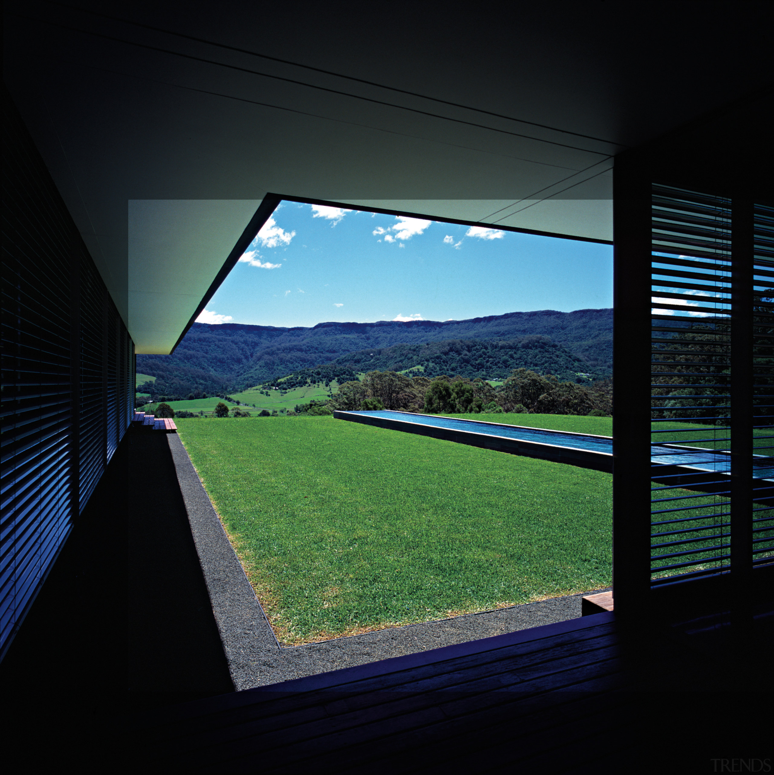 An exterior view of this architecturally designed home architecture, daylighting, grass, house, reflection, sky, structure, sunlight, technology, window, black