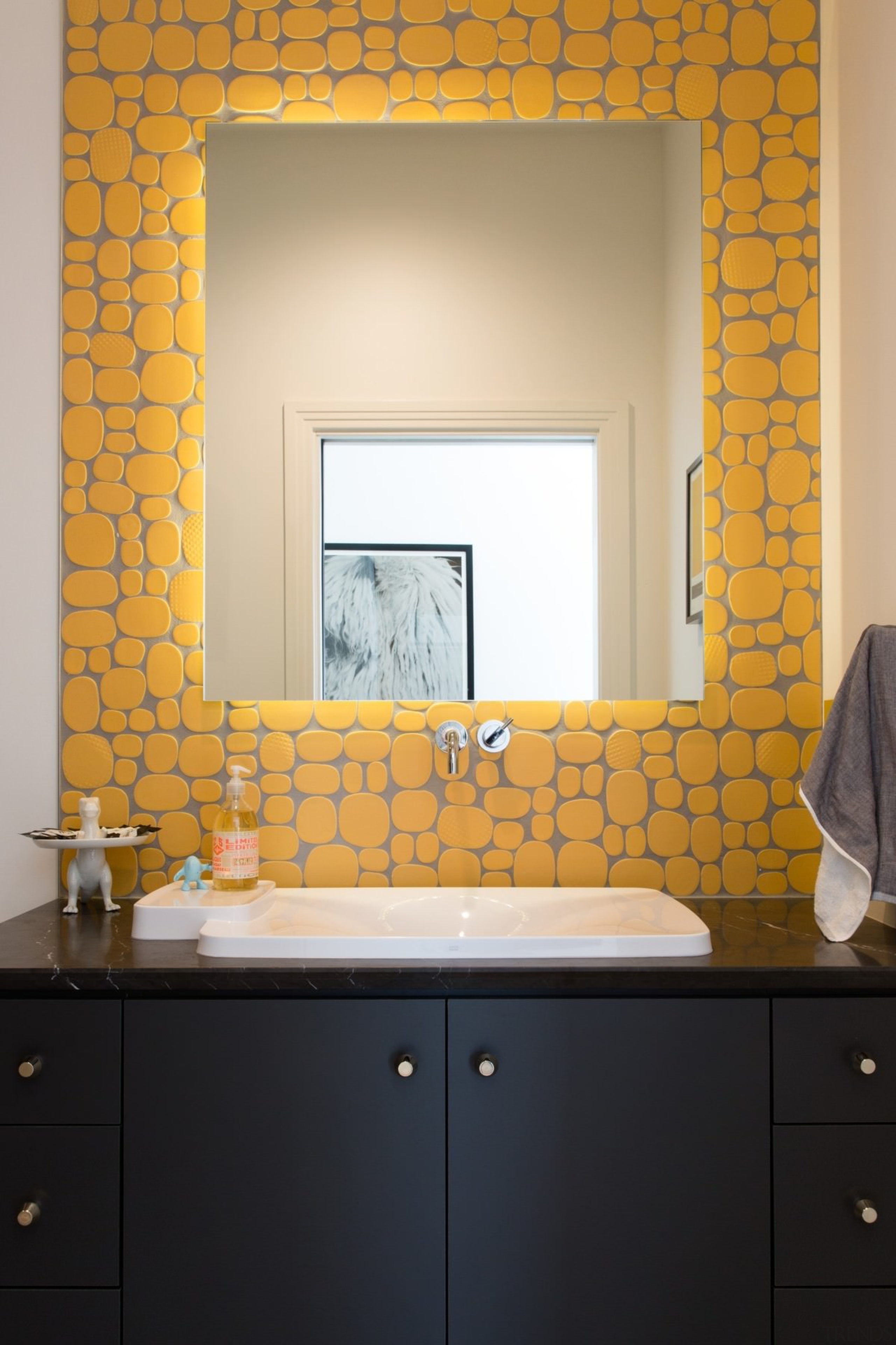 The yellow certainly draws the eye in this bathroom, floor, flooring, interior design, room, sink, tile, wall, window, orange, black
