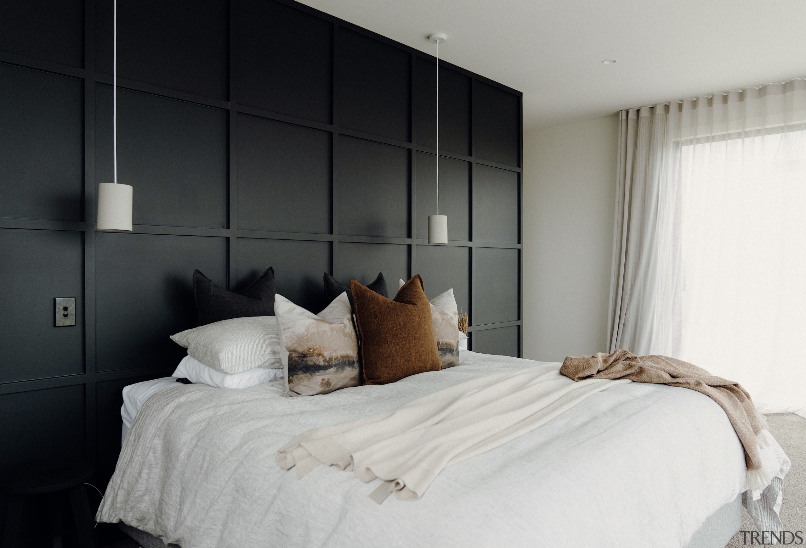 Master bedroom with black panelled wall/headboard. 