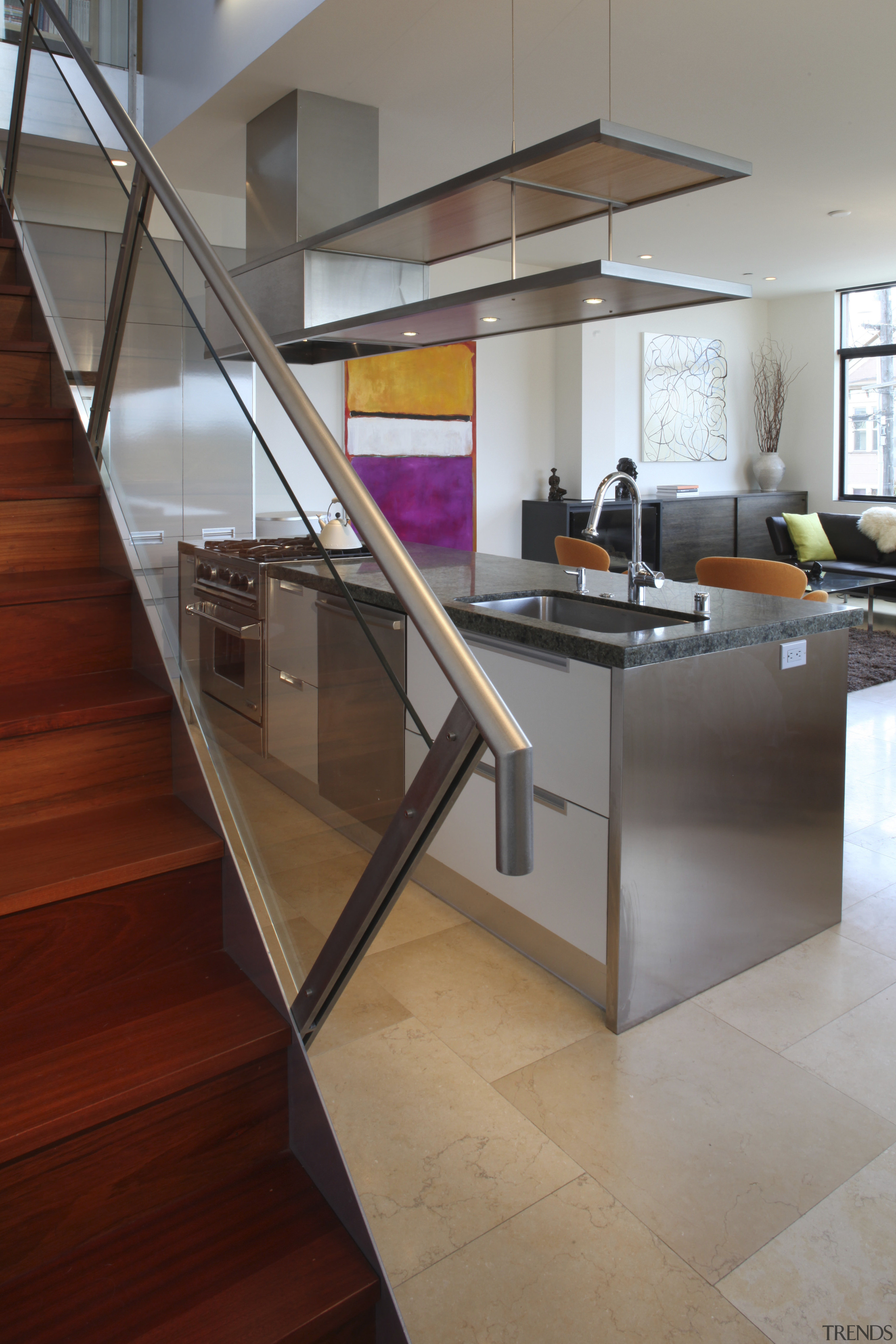 View of a small kitchen beneath a stairway architecture, countertop, floor, flooring, glass, handrail, hardwood, house, interior design, kitchen, laminate flooring, loft, stairs, wood, wood flooring, gray