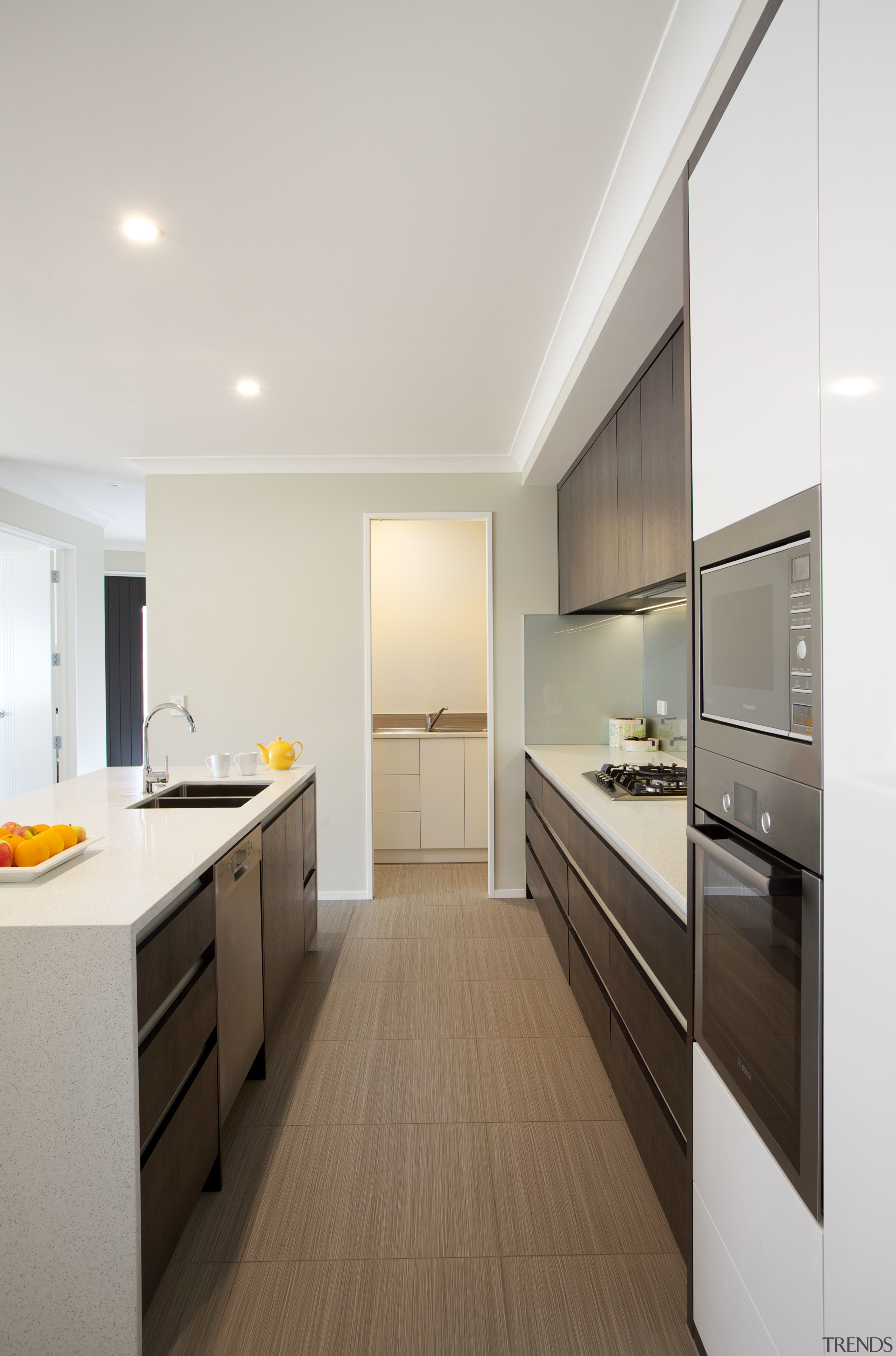 At one end of this kitchen, a scullery cabinetry, countertop, floor, interior design, kitchen, real estate, room, white