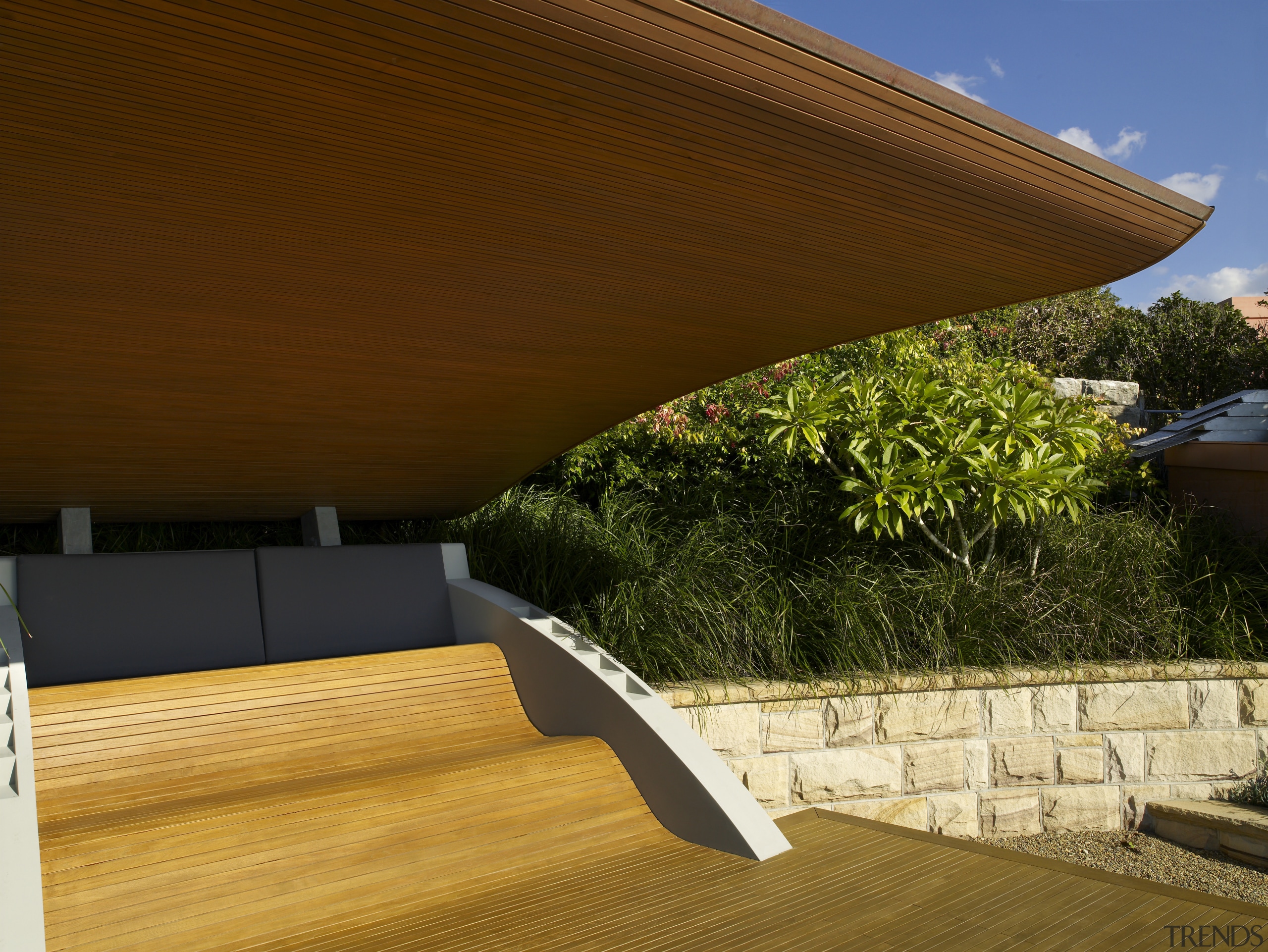 View of a suburban garden which features pavilion architecture, daylighting, house, outdoor furniture, outdoor structure, property, real estate, roof, shade, sunlounger, wood, brown