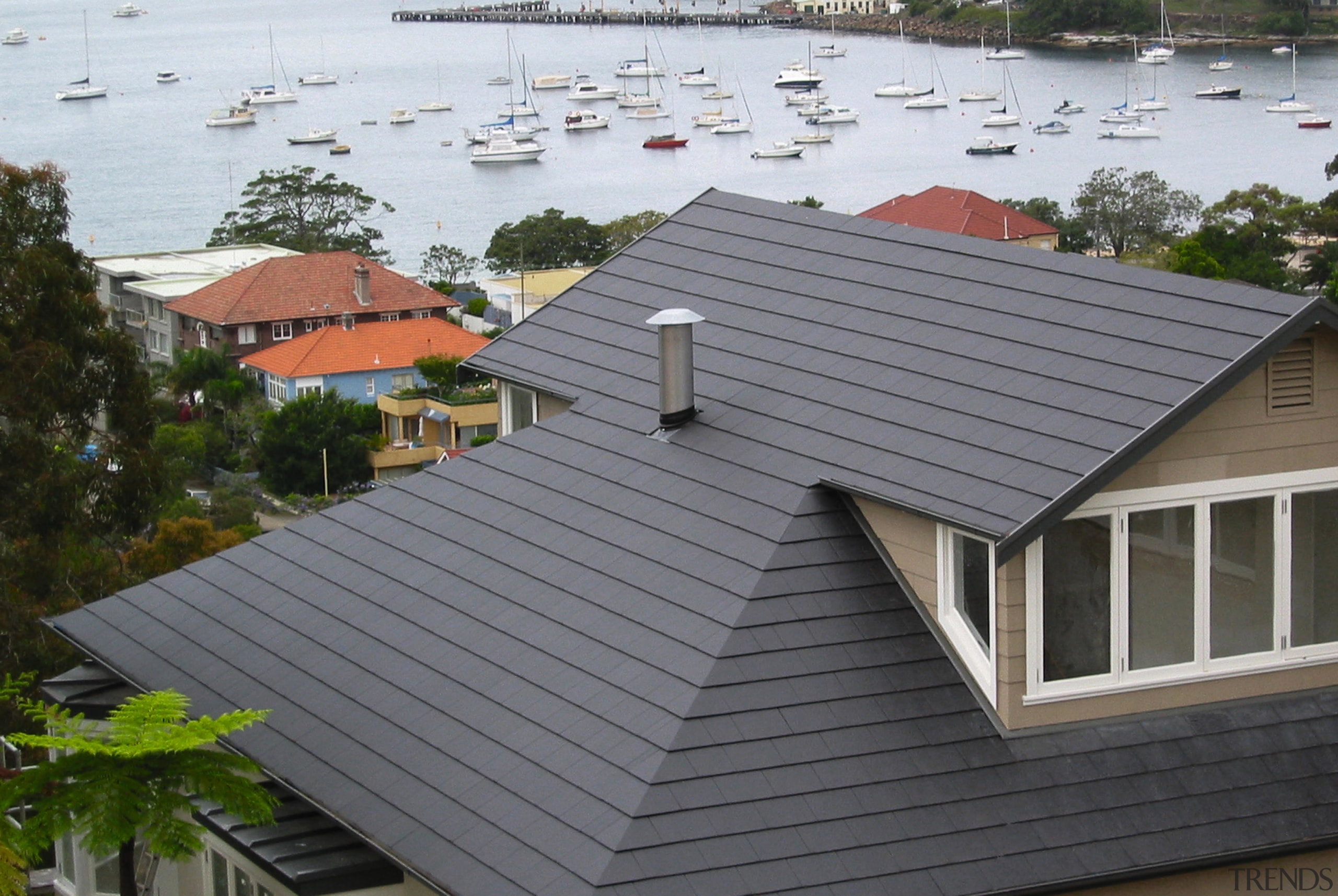 View of roof of house featuring grey roof daylighting, facade, home, house, outdoor structure, real estate, residential area, roof, siding, gray