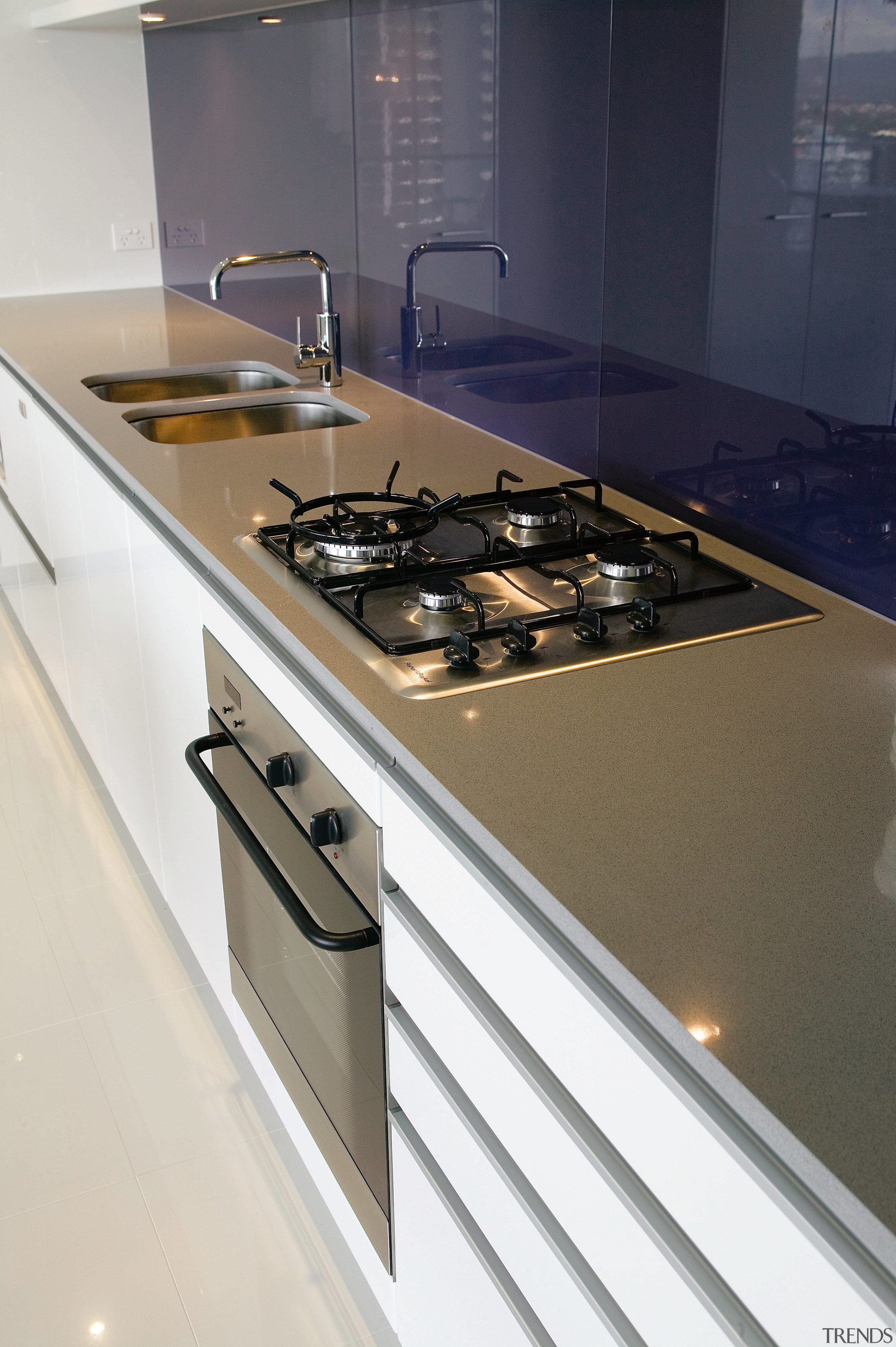 A view of this kitchen featuring the latest countertop, kitchen, kitchen stove, sink, white