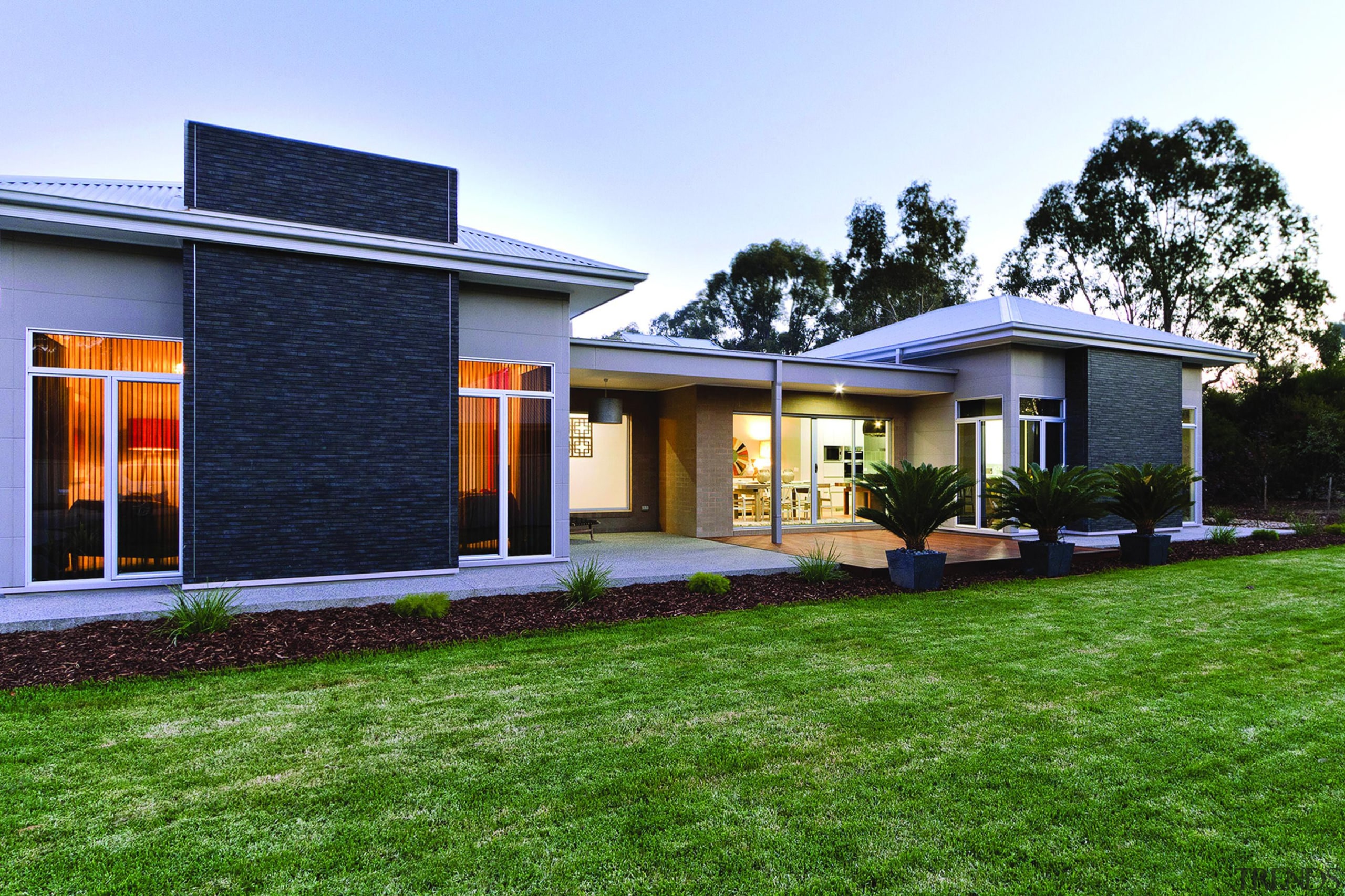 With a depth of colour and intricate texture architecture, backyard, cottage, elevation, estate, facade, grass, home, house, property, real estate, residential area, roof, siding, window, yard, green