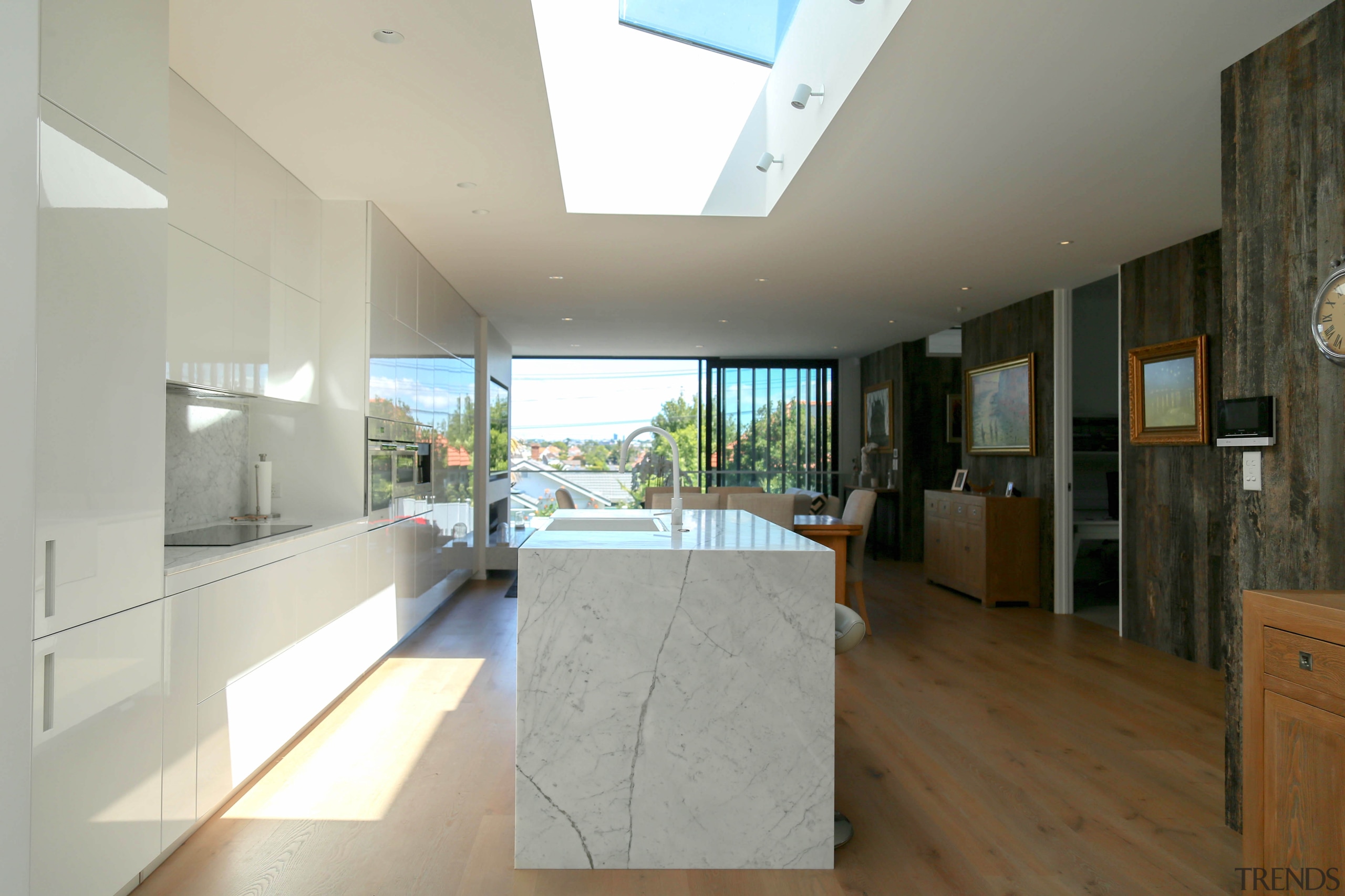 This through kitchen forms an understated part of apartment, architecture, building, ceiling, daylighting, floor, flooring, furniture, hardwood, home, house, interior design, loft, property, real estate, room, window, wood flooring, gray