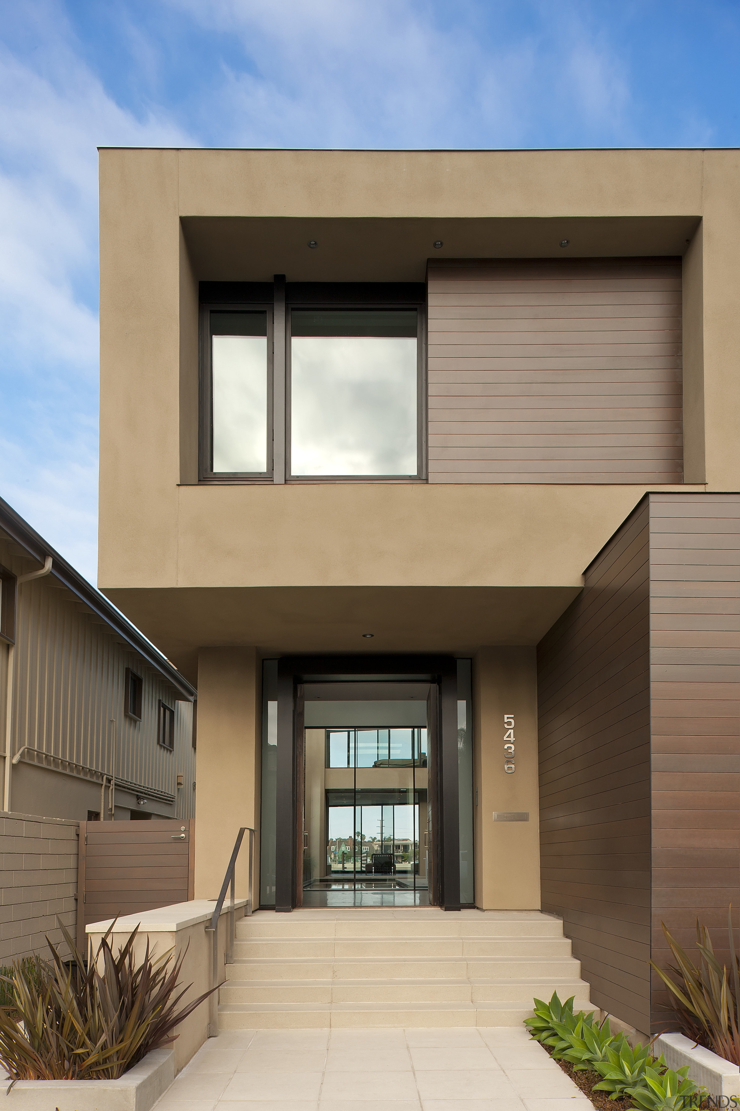 A glimpse of a central open-air courtyard and architecture, building, commercial building, elevation, estate, facade, home, house, property, real estate, residential area, siding, window, brown, orange