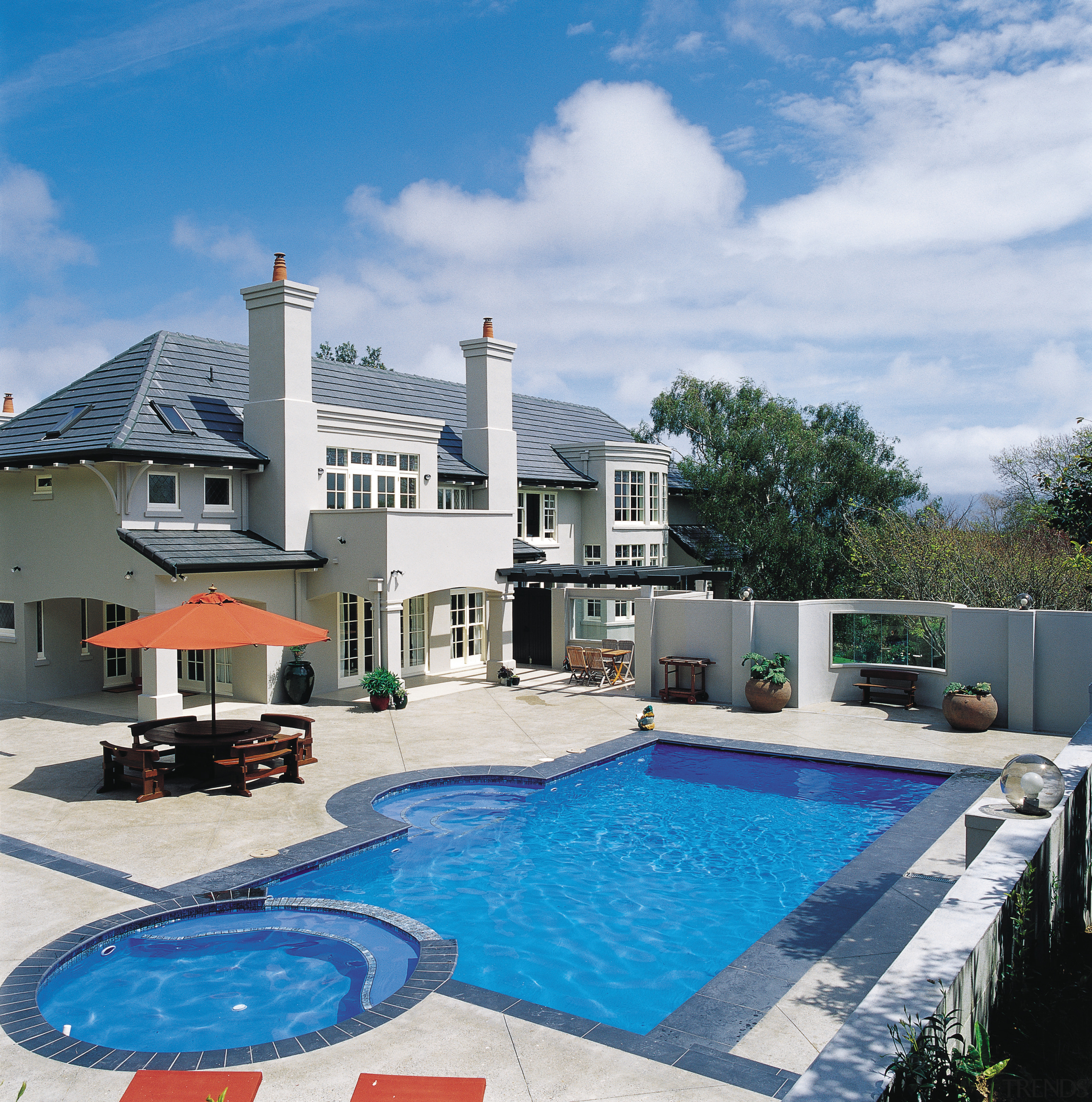 A view of the back of this large estate, home, house, leisure, property, real estate, sky, swimming pool, villa, white, teal