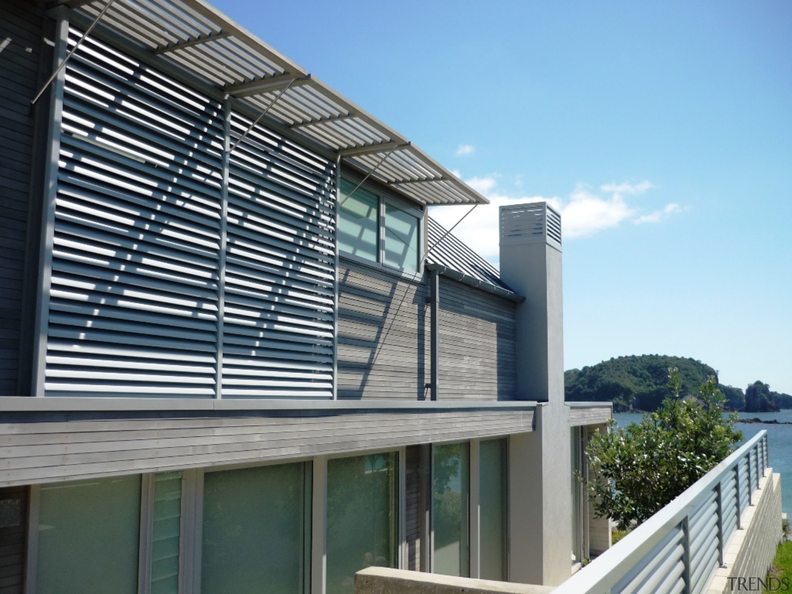 78580_louvretec-new-zealand-ltd_1556758086 - architecture | balcony | building | architecture, balcony, building, corporate headquarters, daylighting, facade, glass, home, house, material property, metal, property, real estate, residential area, siding, window, teal, black