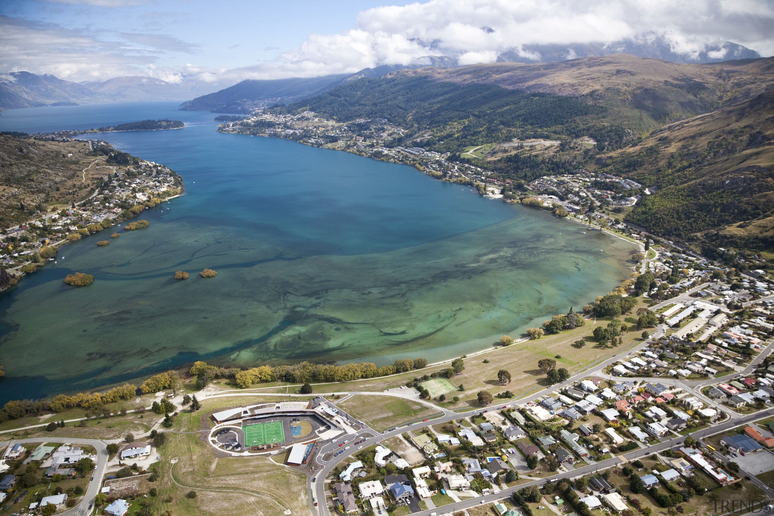 View of Remarkables Primary School in Queenstown. - aerial photography, bay, bird's eye view, city, coast, coastal and oceanic landforms, lake, photography, tourism, water, water resources, teal