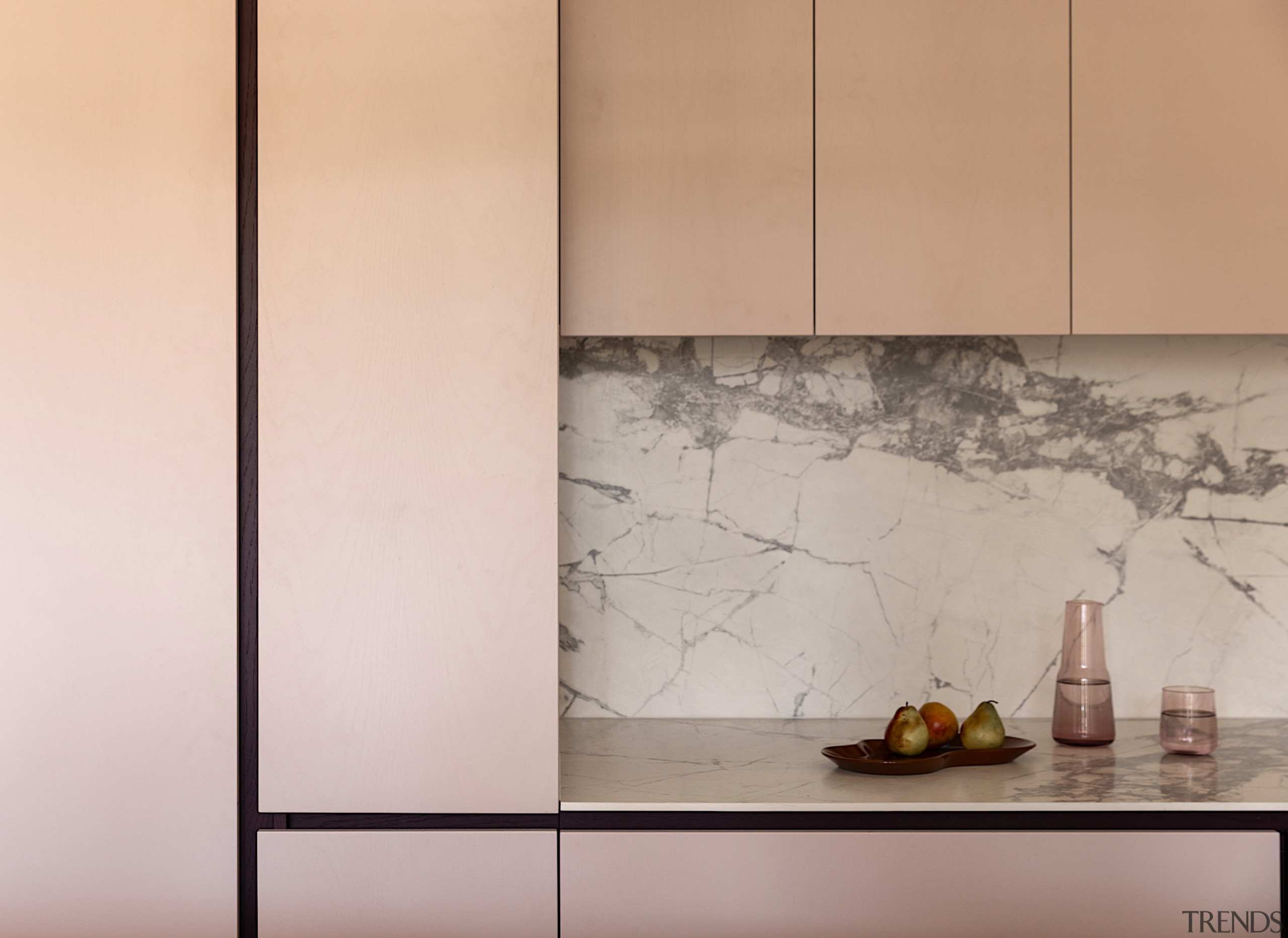 Custom joinery incorporates integrated handles and shadowlines for 