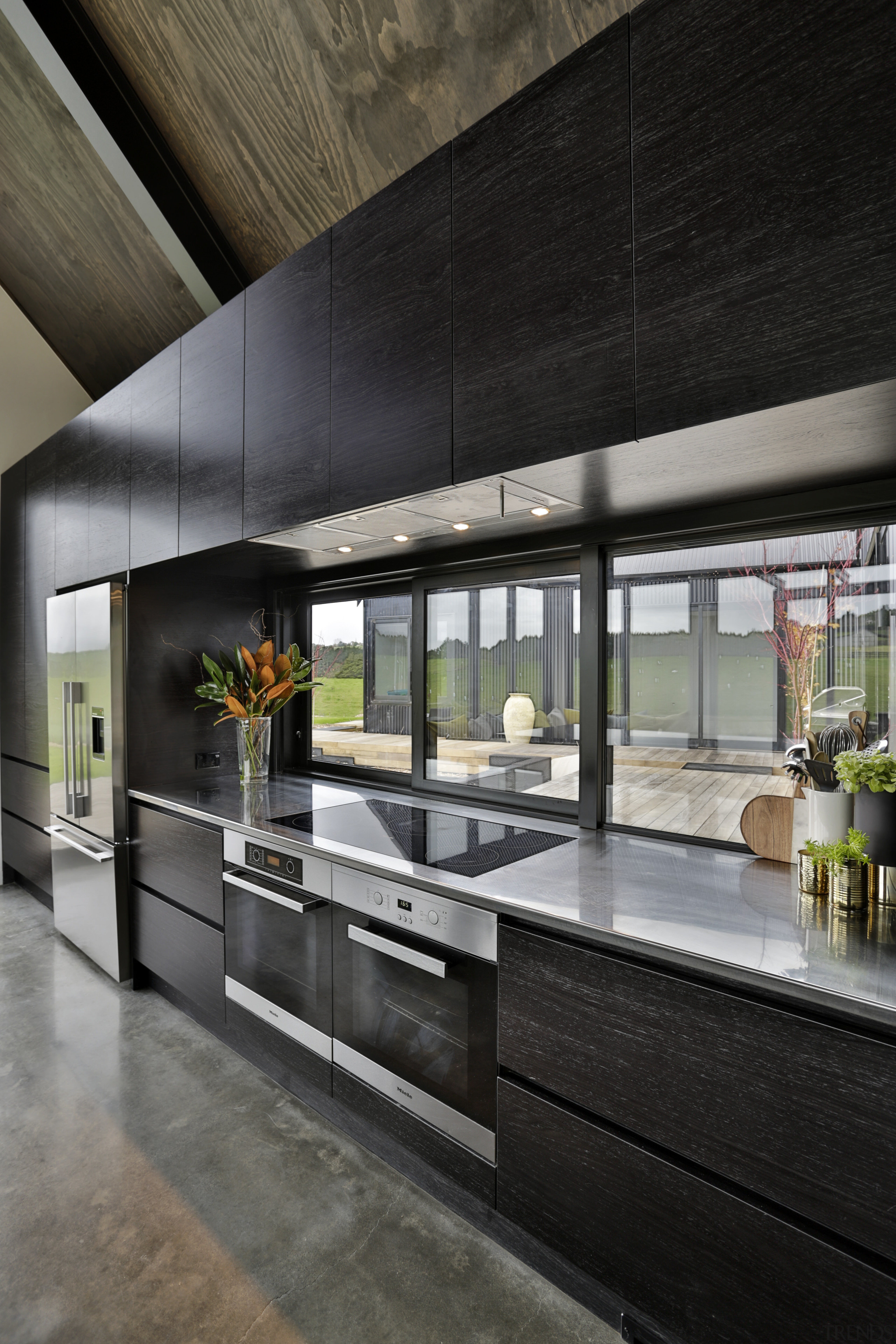 Carlielle Kitchens created this semi-industrial kitchen with recessed countertop, interior design, lobby, black, gray