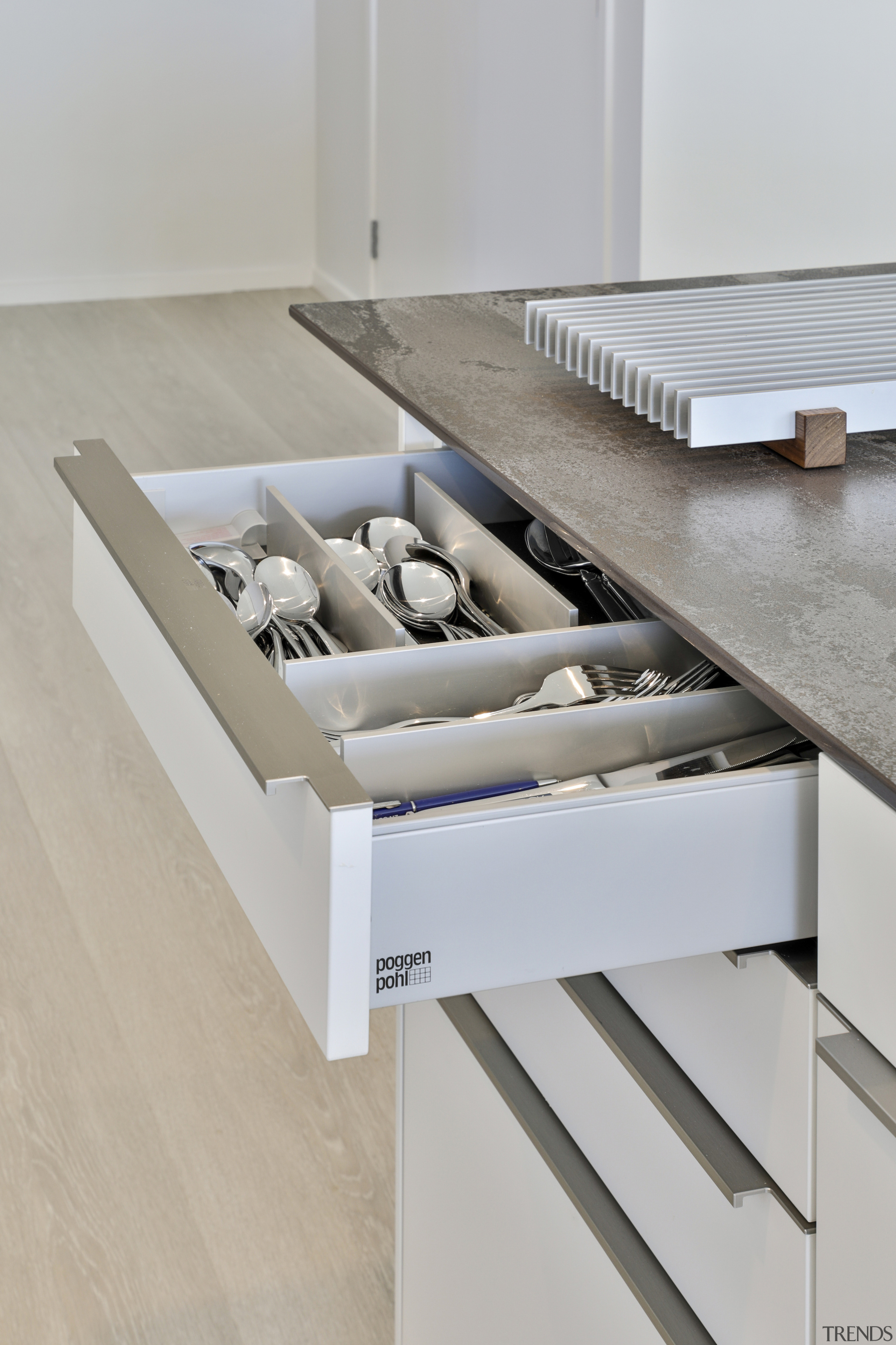 Dedicated storage in the Poggenpohl cabinetry helps with 