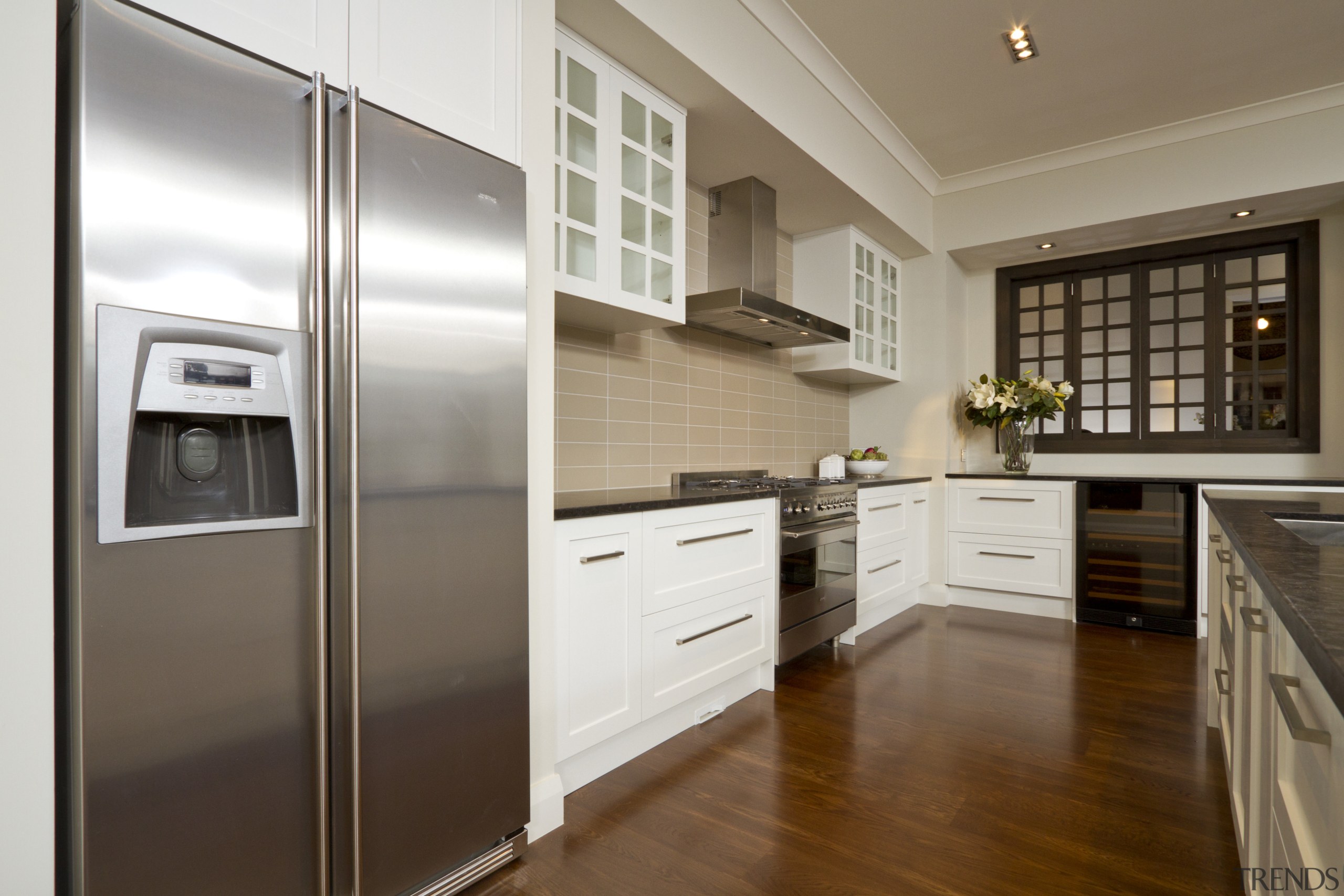 View of kitchen with wooden flooring, dark benchtops cabinetry, countertop, cuisine classique, floor, home appliance, interior design, kitchen, real estate, room, brown, white